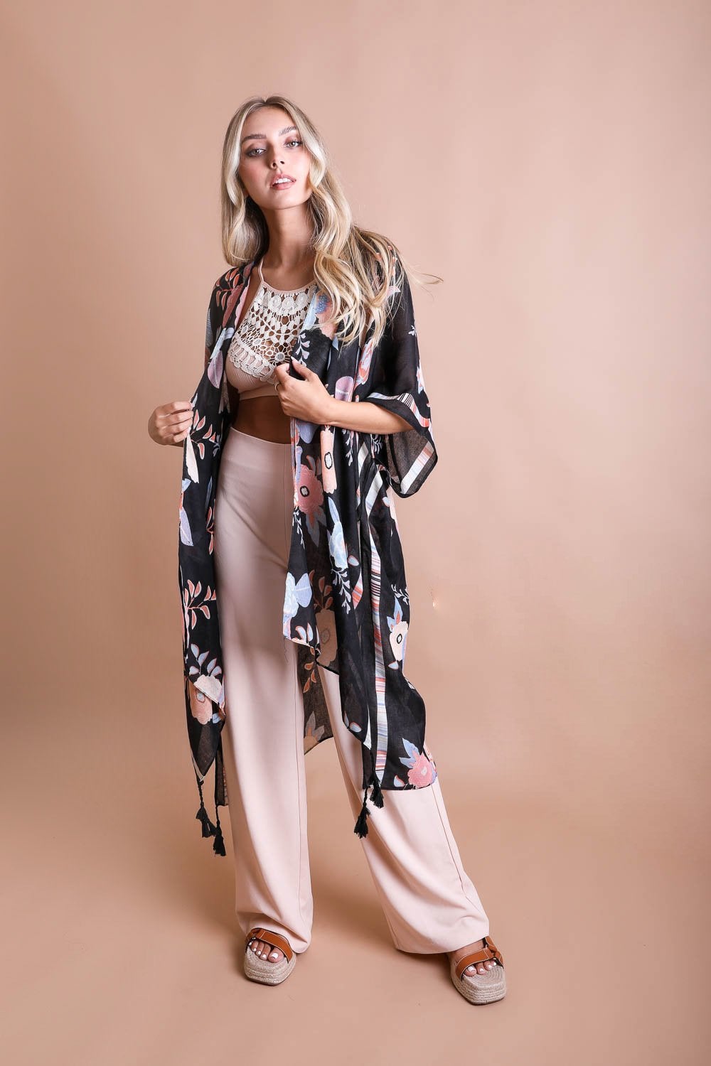 A stylish Wallflower Bloom Kimono with floral patterns and tassels, perfect for fall mornings.