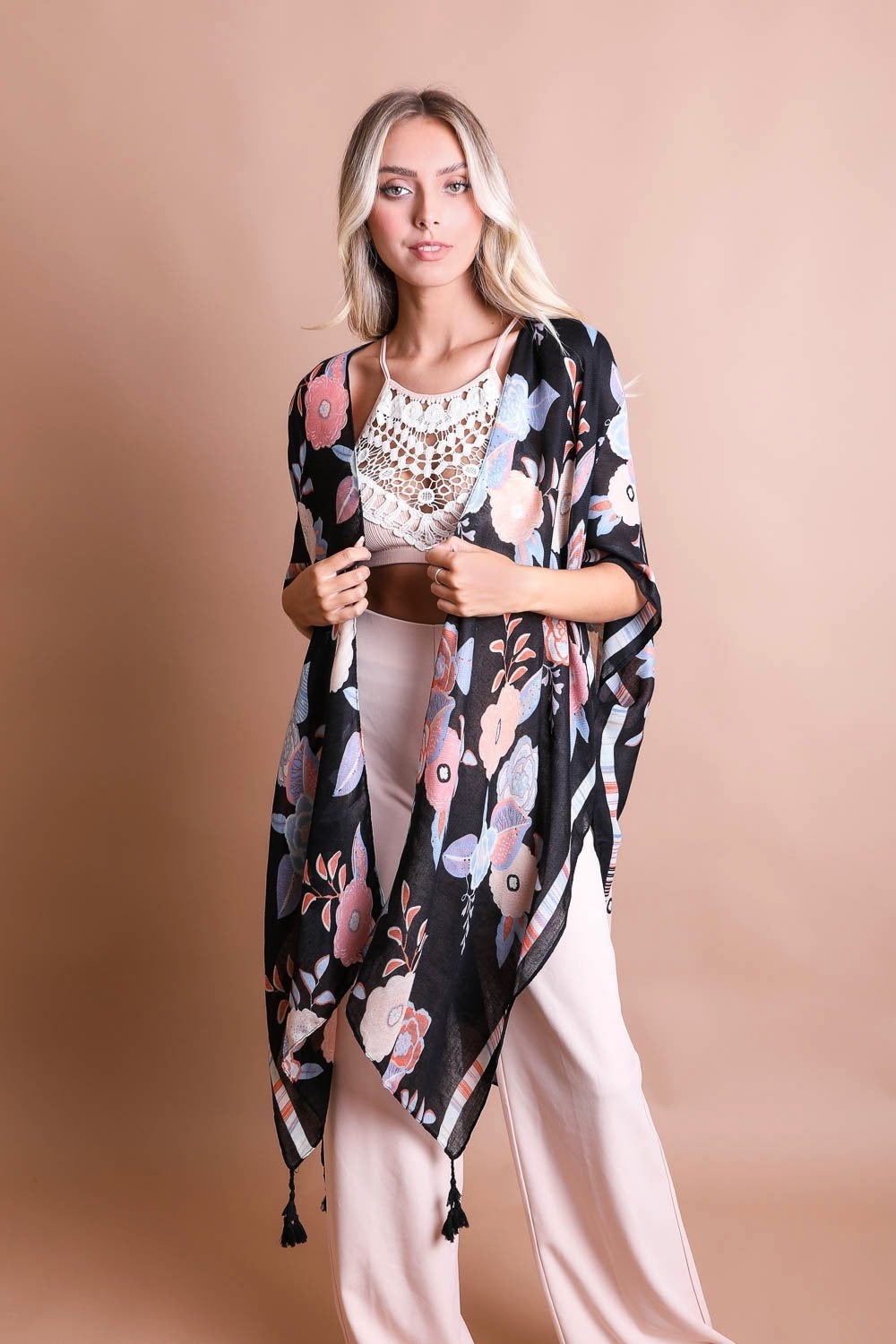 A stylish Wallflower Bloom Kimono with floral patterns and tassels, perfect for fall mornings.