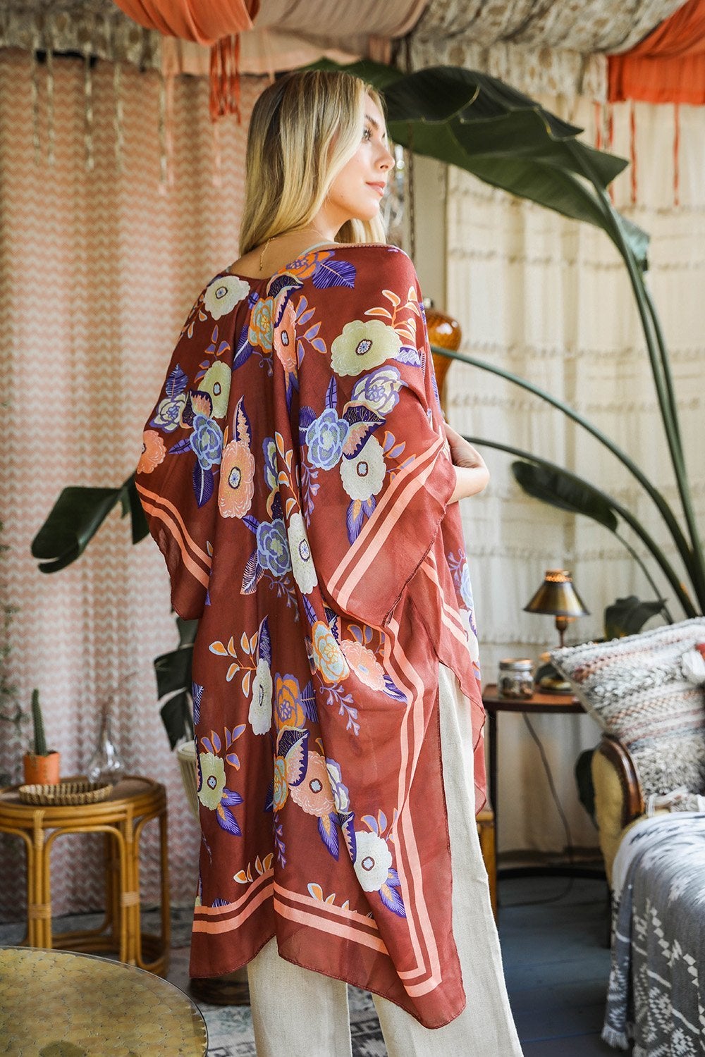 A stylish Wallflower Bloom Kimono with floral patterns and tassels, perfect for fall mornings.