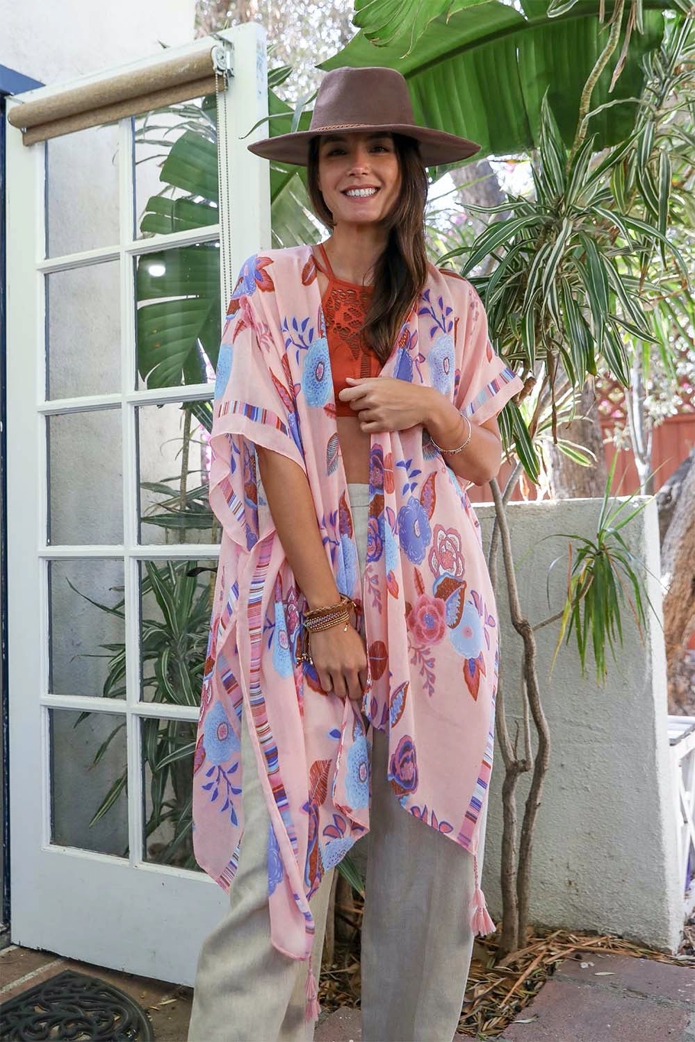 A stylish Wallflower Bloom Kimono with floral patterns and tassels, perfect for fall mornings.