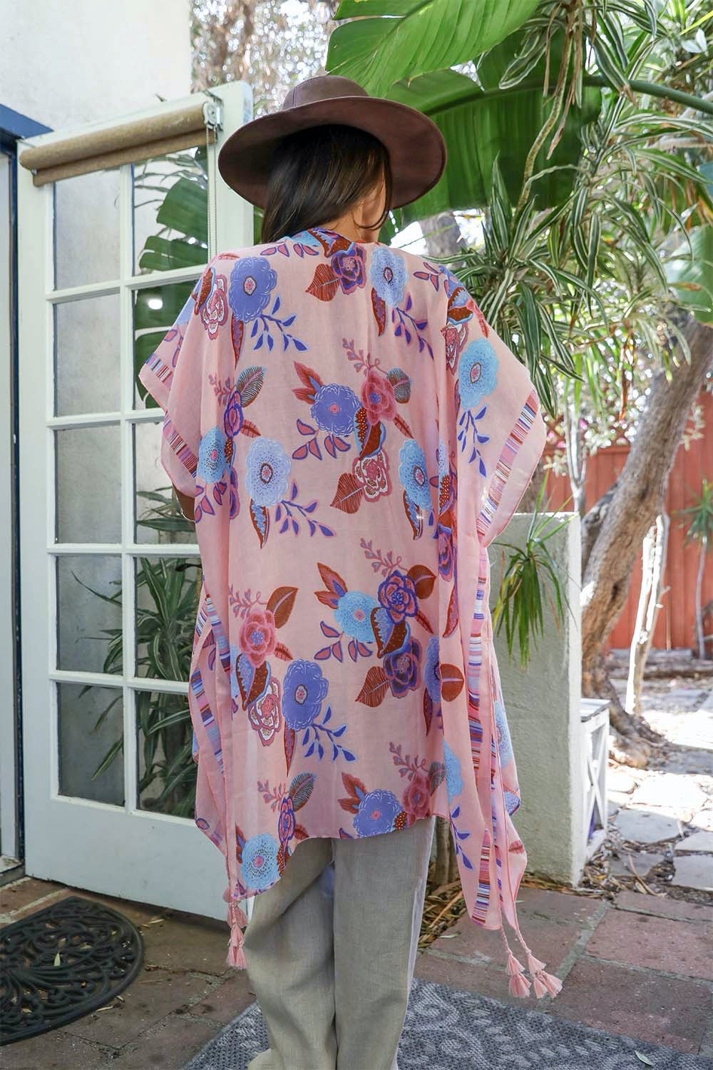 A stylish Wallflower Bloom Kimono with floral patterns and tassels, perfect for fall mornings.