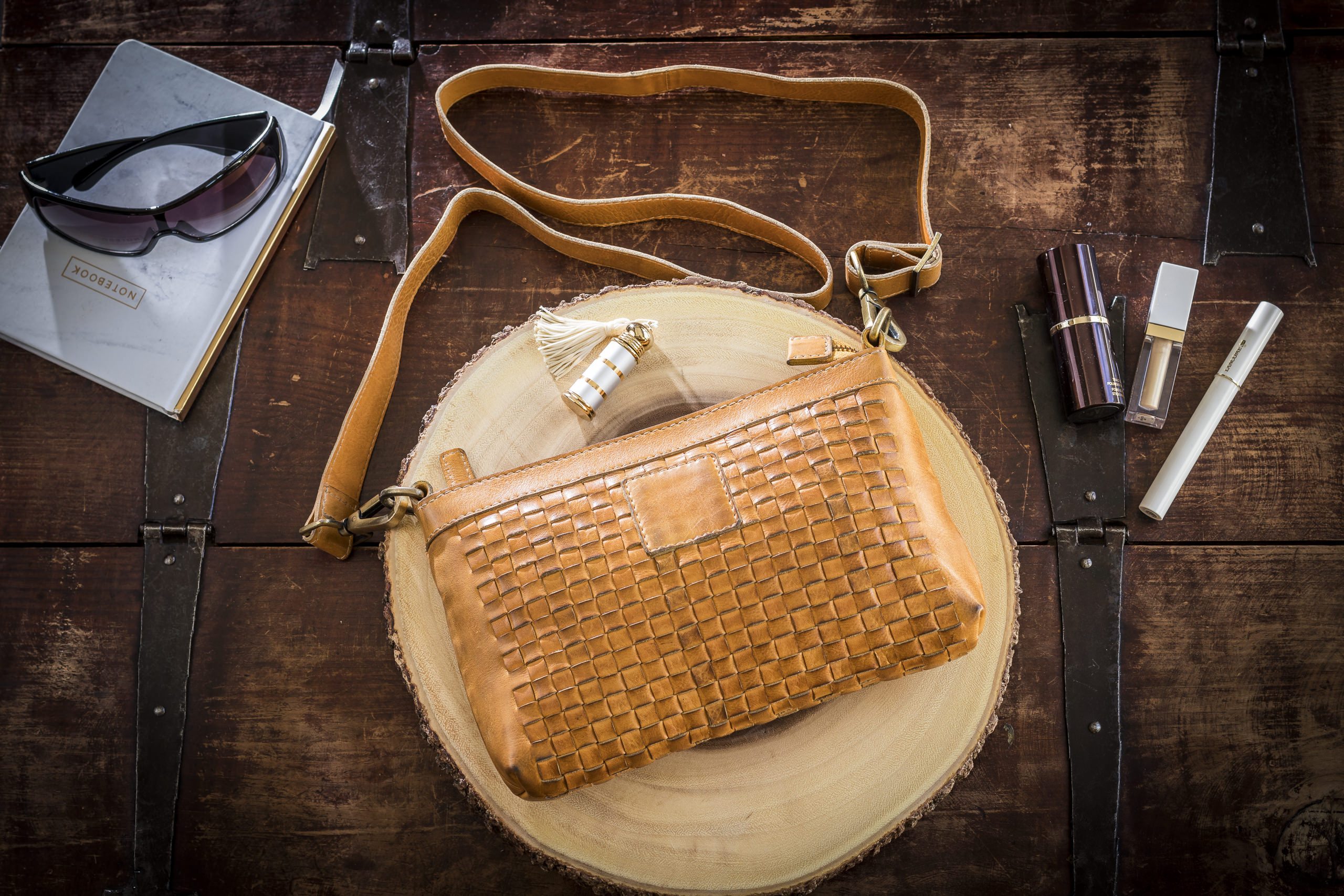 Stylish Weaved Crossbody bag made of genuine washed leather with adjustable strap and zipper pockets.