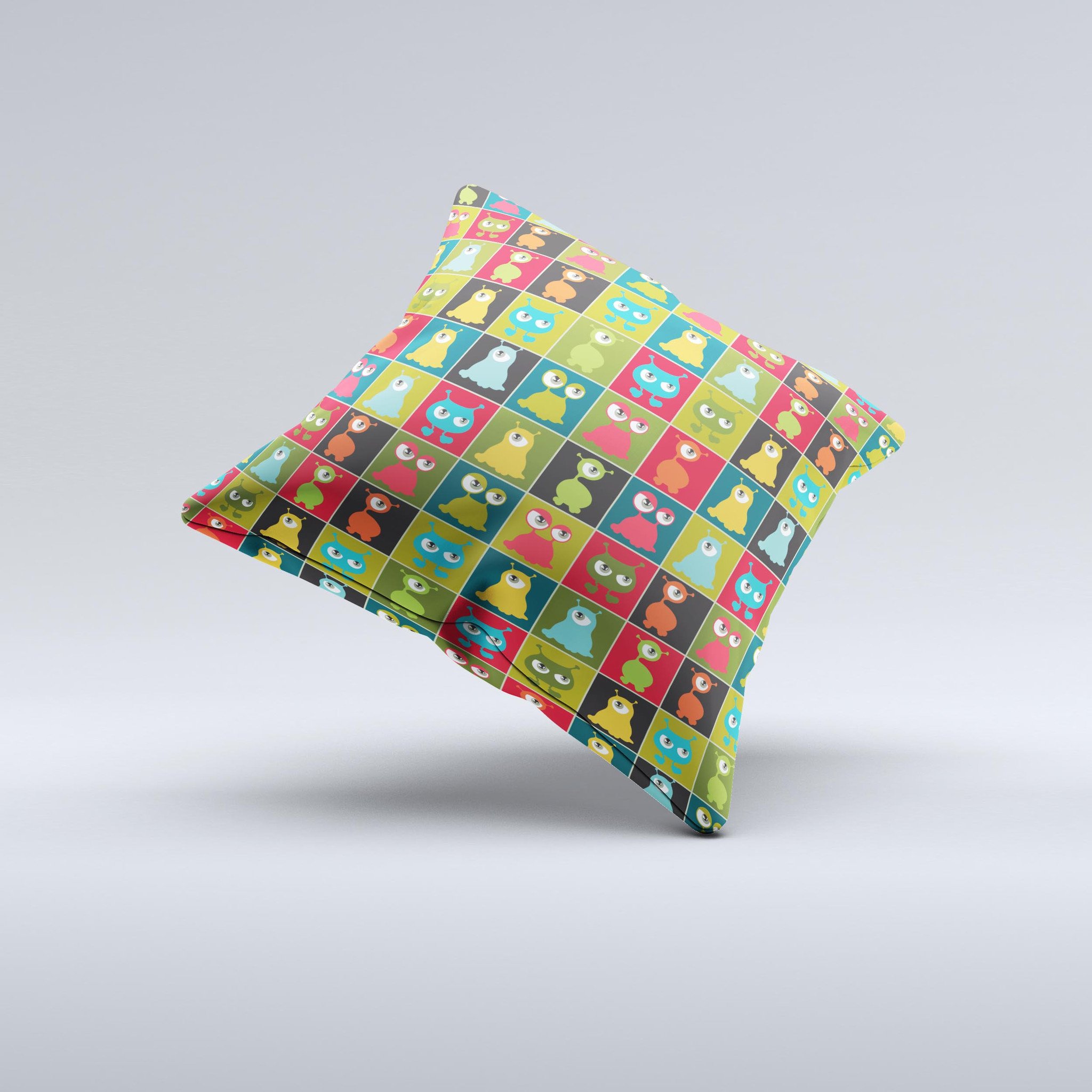 A decorative throw pillow featuring weird abstract eyeball creatures, showcasing vibrant colors and unique hand-produced graphics.