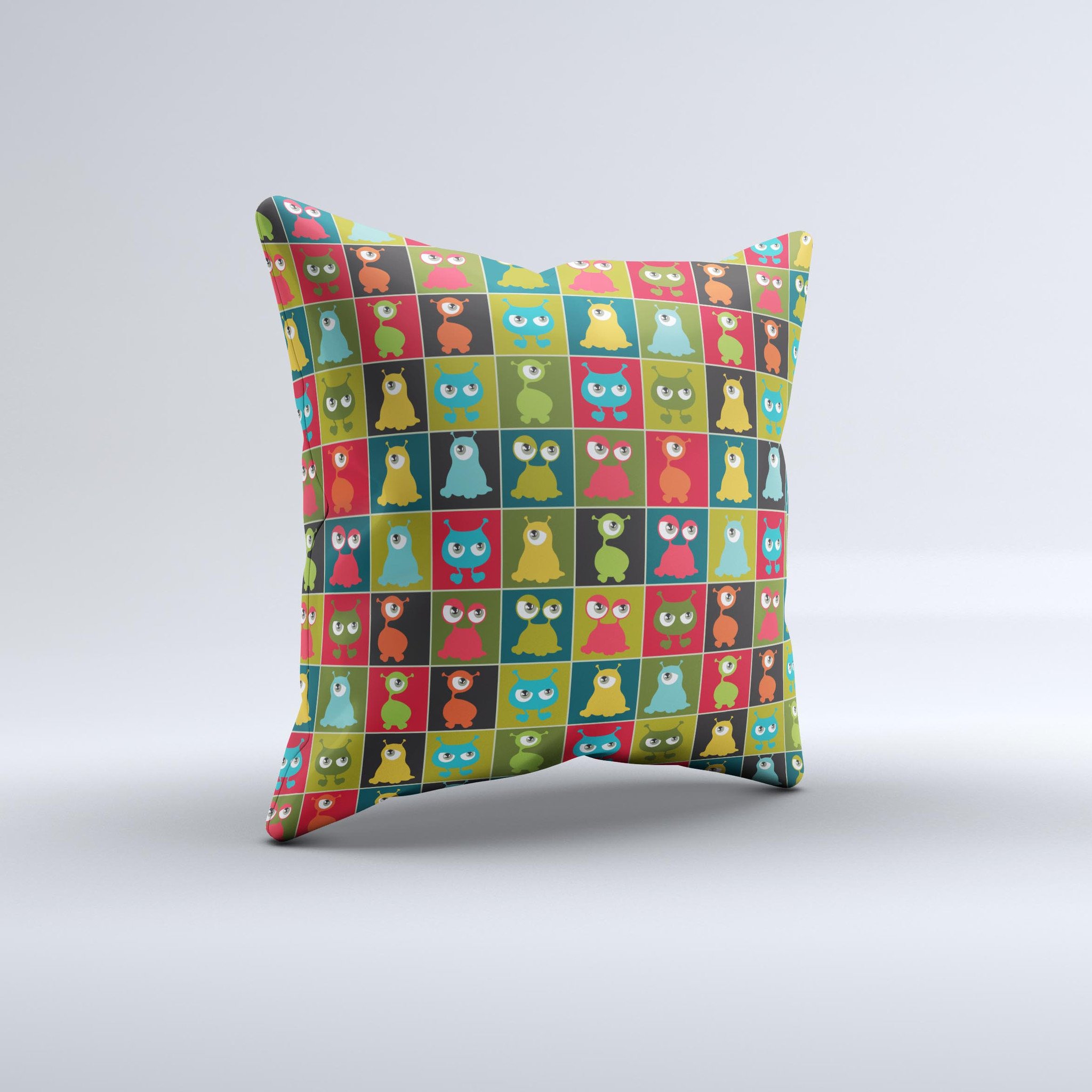 A decorative throw pillow featuring weird abstract eyeball creatures, showcasing vibrant colors and unique hand-produced graphics.