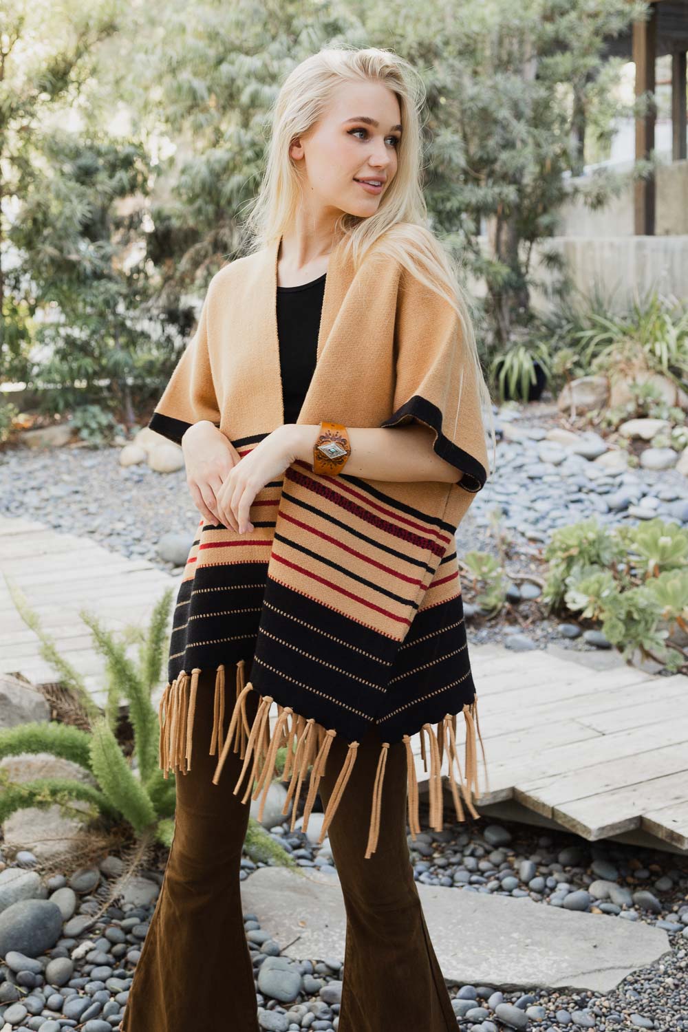 A stylish Western Luxe Fringed Ruana featuring a chic fringe design, perfect for winter wear.