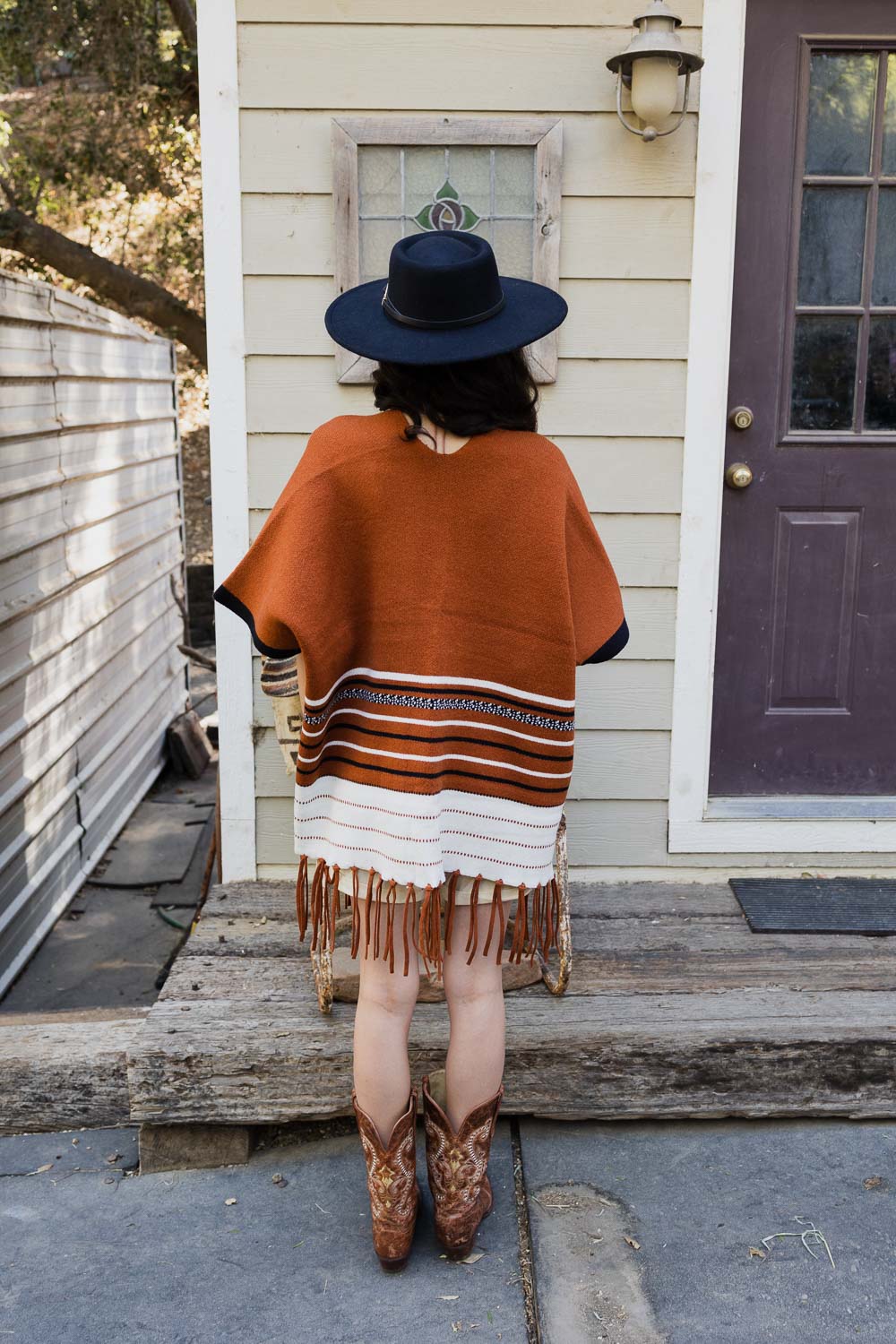 A stylish Western Luxe Fringed Ruana featuring a chic fringe design, perfect for winter wear.