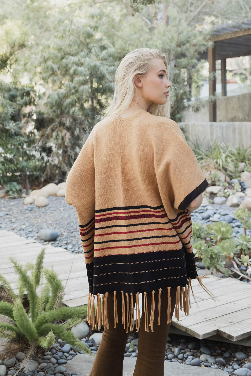 A stylish Western Luxe Fringed Ruana featuring a chic fringe design, perfect for winter wear.