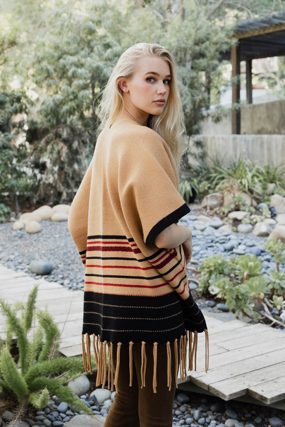 A stylish Western Luxe Fringed Ruana featuring a chic fringe design, perfect for winter wear.