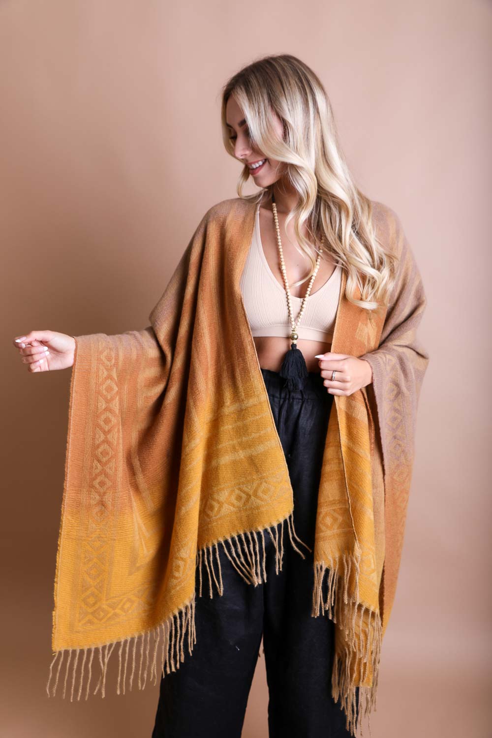 A colorful Western style serape with tassels, showcasing a blend of bohemian colors, perfect for layering and personal expression.