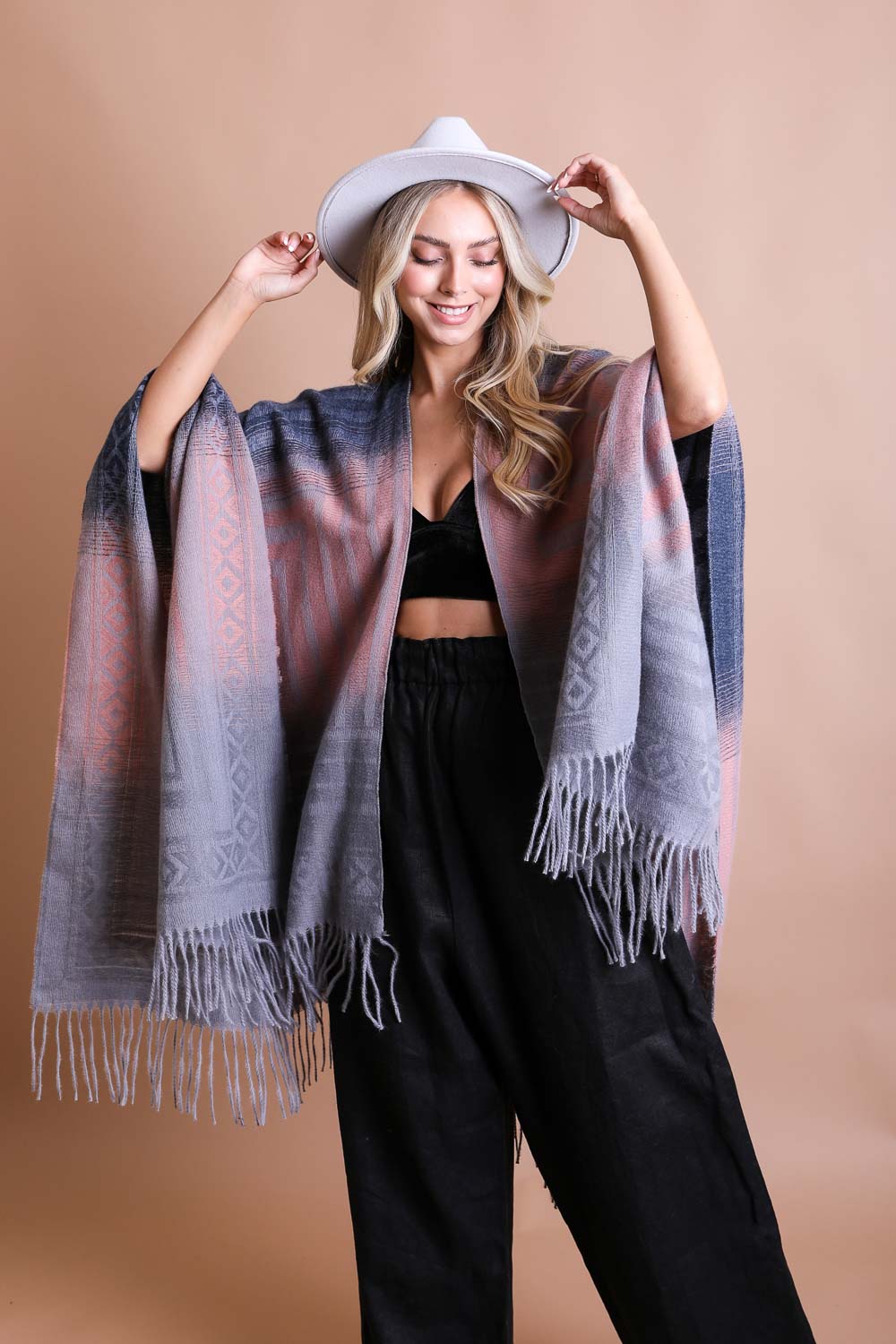 A colorful Western style serape with tassels, showcasing a blend of bohemian colors, perfect for layering and personal expression.