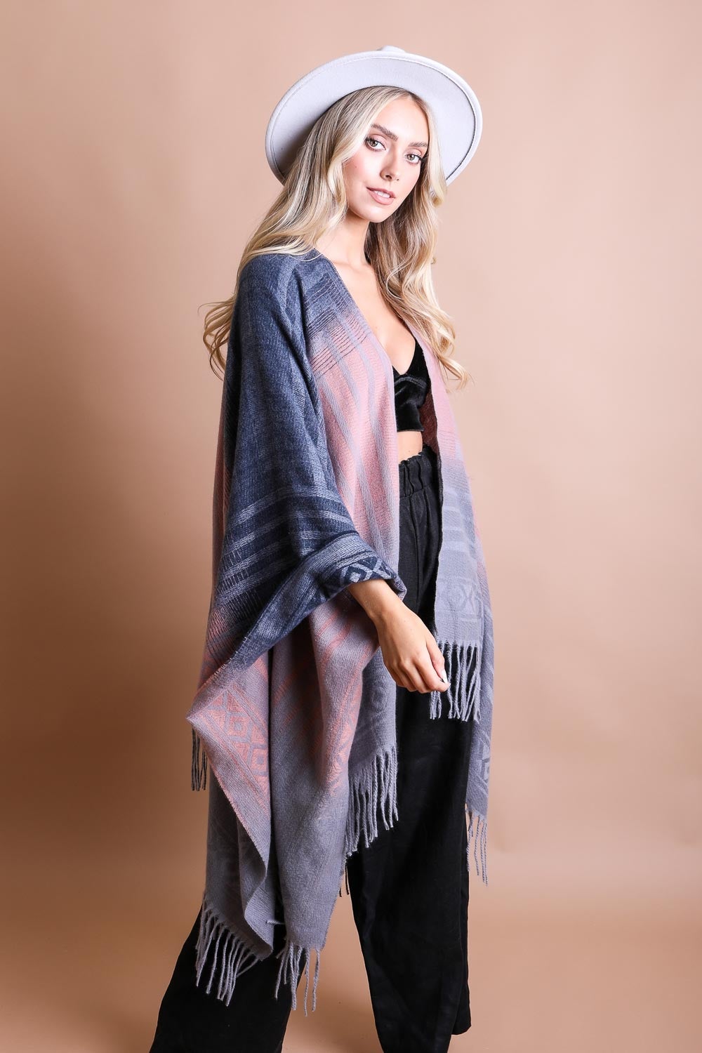 A colorful Western style serape with tassels, showcasing a blend of bohemian colors, perfect for layering and personal expression.