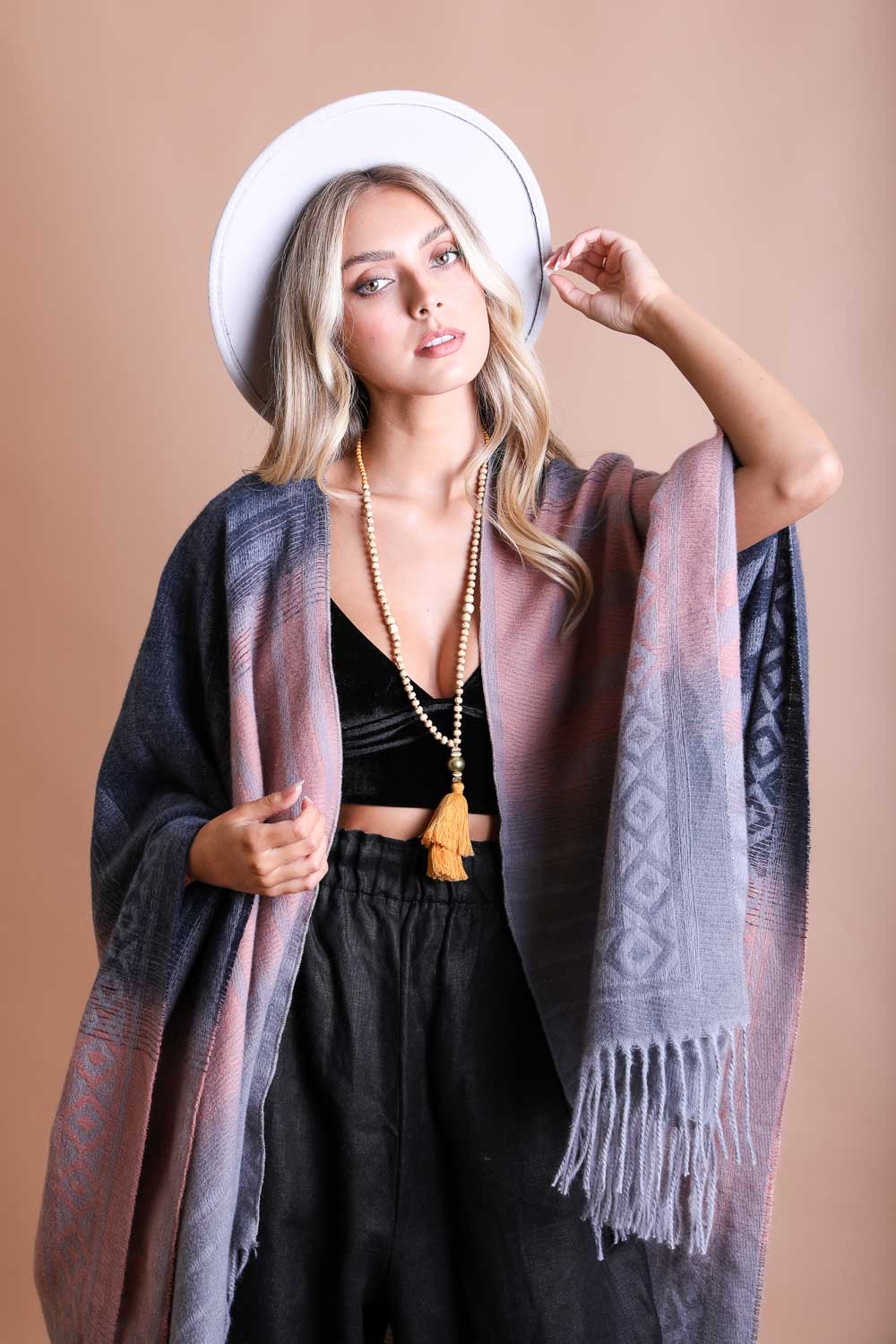 A colorful Western style serape with tassels, showcasing a blend of bohemian colors, perfect for layering and personal expression.