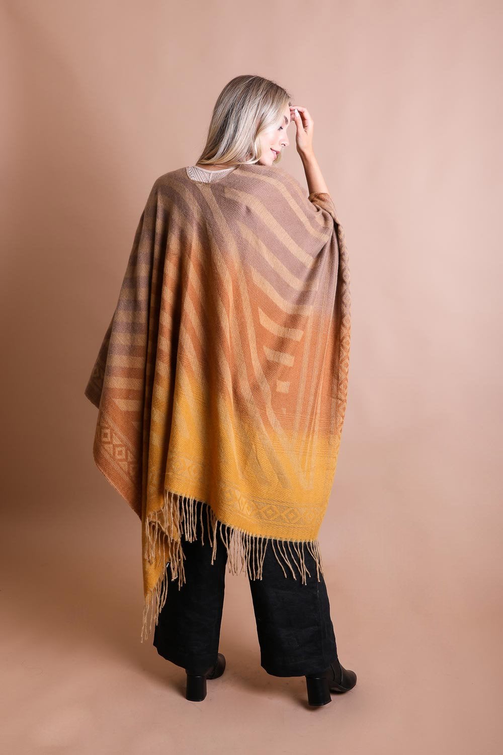 A colorful Western style serape with tassels, showcasing a blend of bohemian colors, perfect for layering and personal expression.