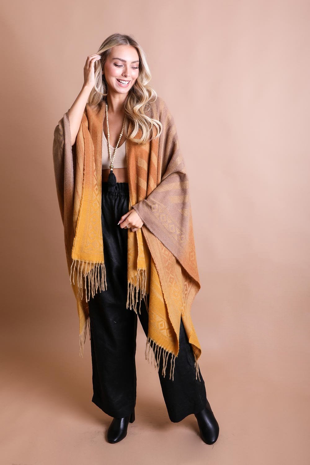 A colorful Western style serape with tassels, showcasing a blend of bohemian colors, perfect for layering and personal expression.