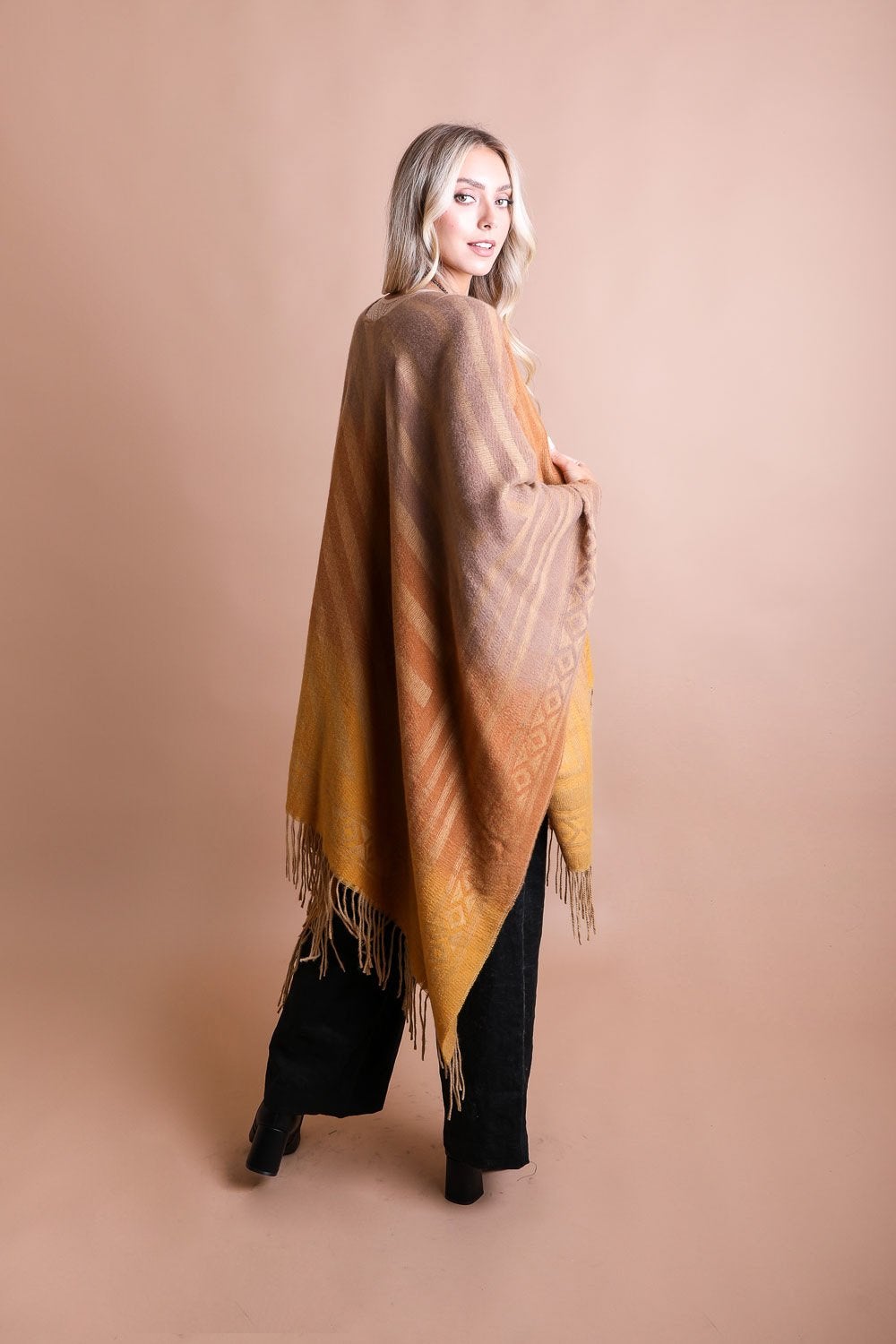 A colorful Western style serape with tassels, showcasing a blend of bohemian colors, perfect for layering and personal expression.