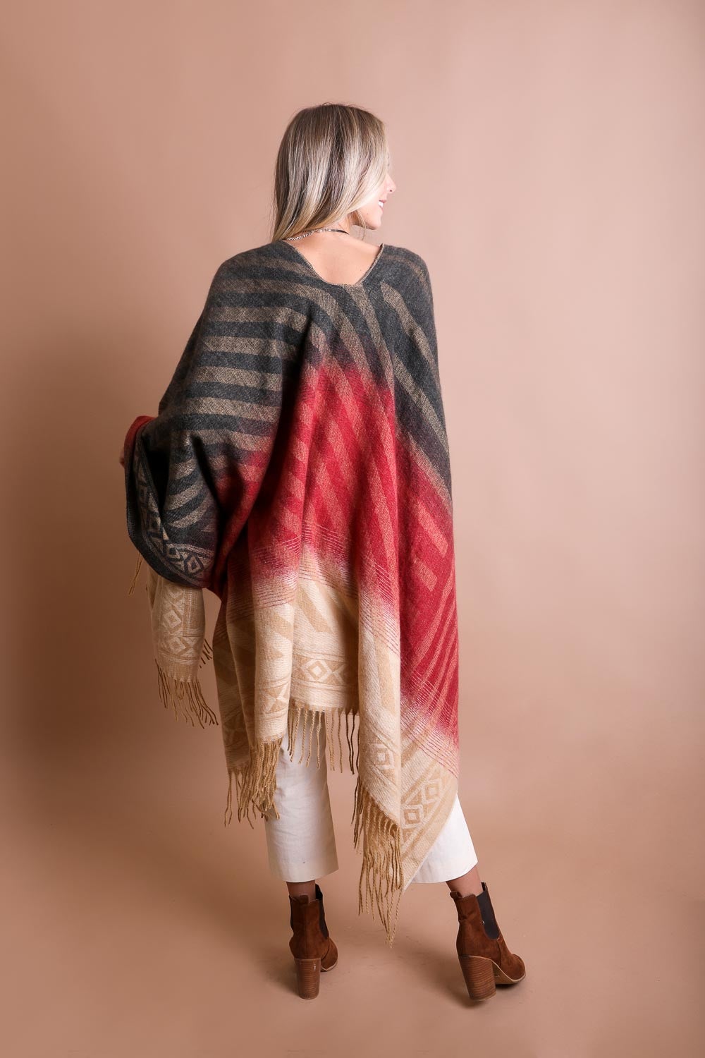 A colorful Western style serape with tassels, showcasing a blend of bohemian colors, perfect for layering and personal expression.