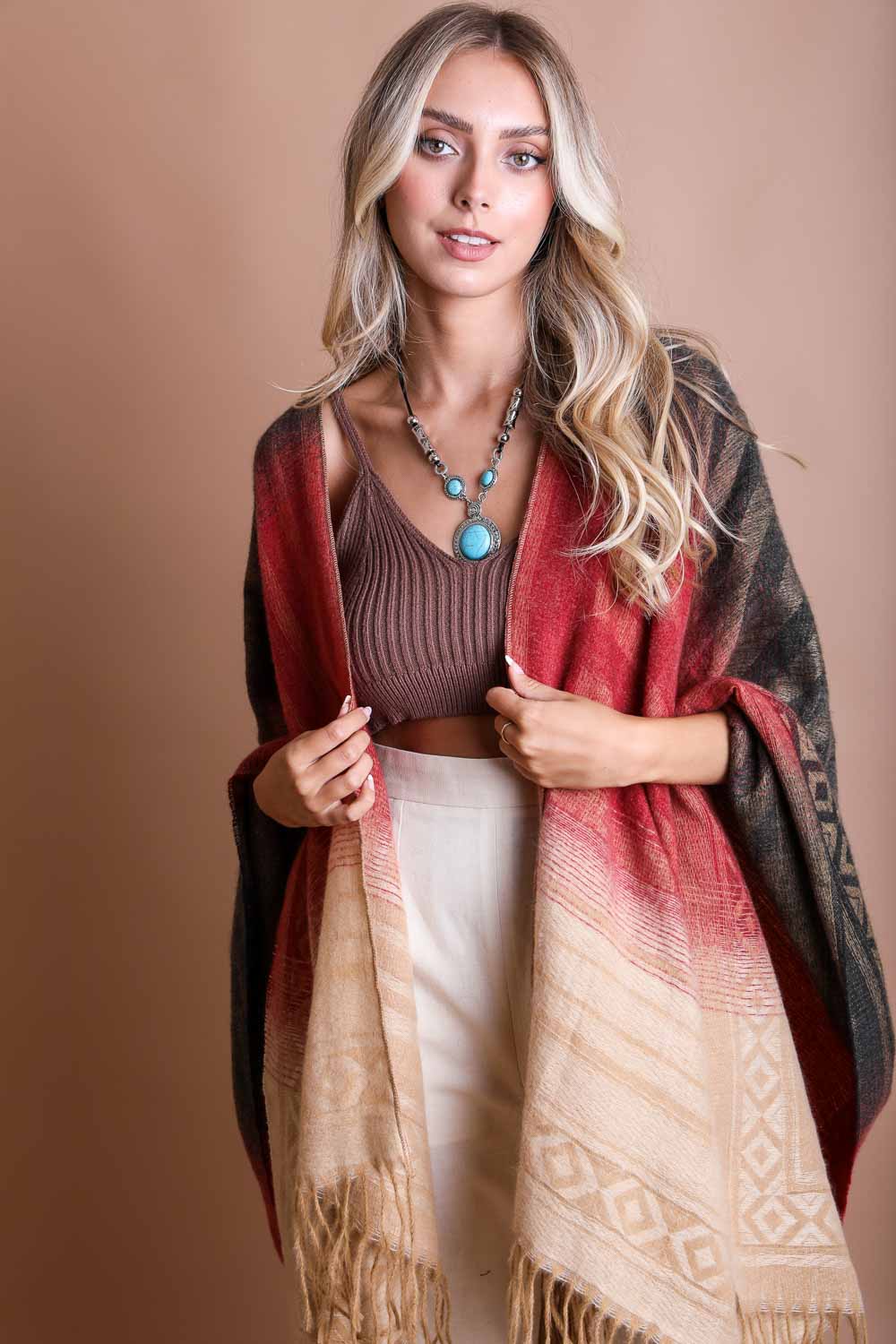 A colorful Western style serape with tassels, showcasing a blend of bohemian colors, perfect for layering and personal expression.