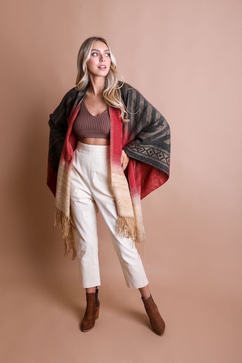 A colorful Western style serape with tassels, showcasing a blend of bohemian colors, perfect for layering and personal expression.