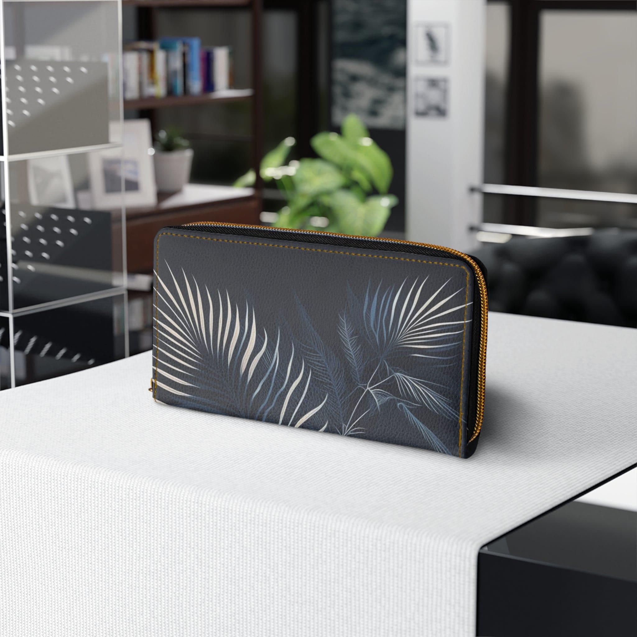 Stylish navy blue wallet featuring white line art of palm tree leaves, perfect for women.