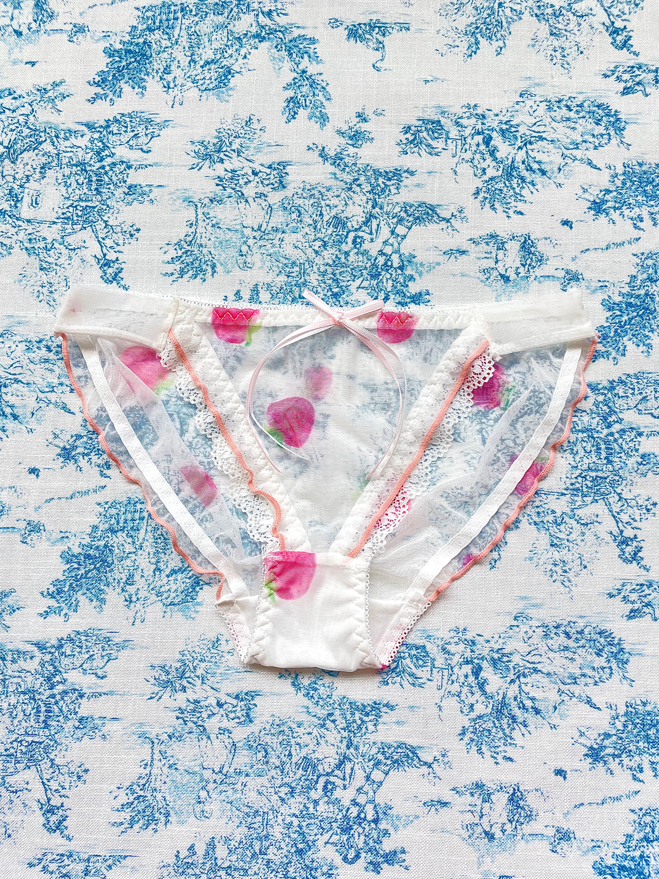 Elegant White Mesh Strawberry Panty with peach lettuce trim and lace detail, featuring a charming bow.