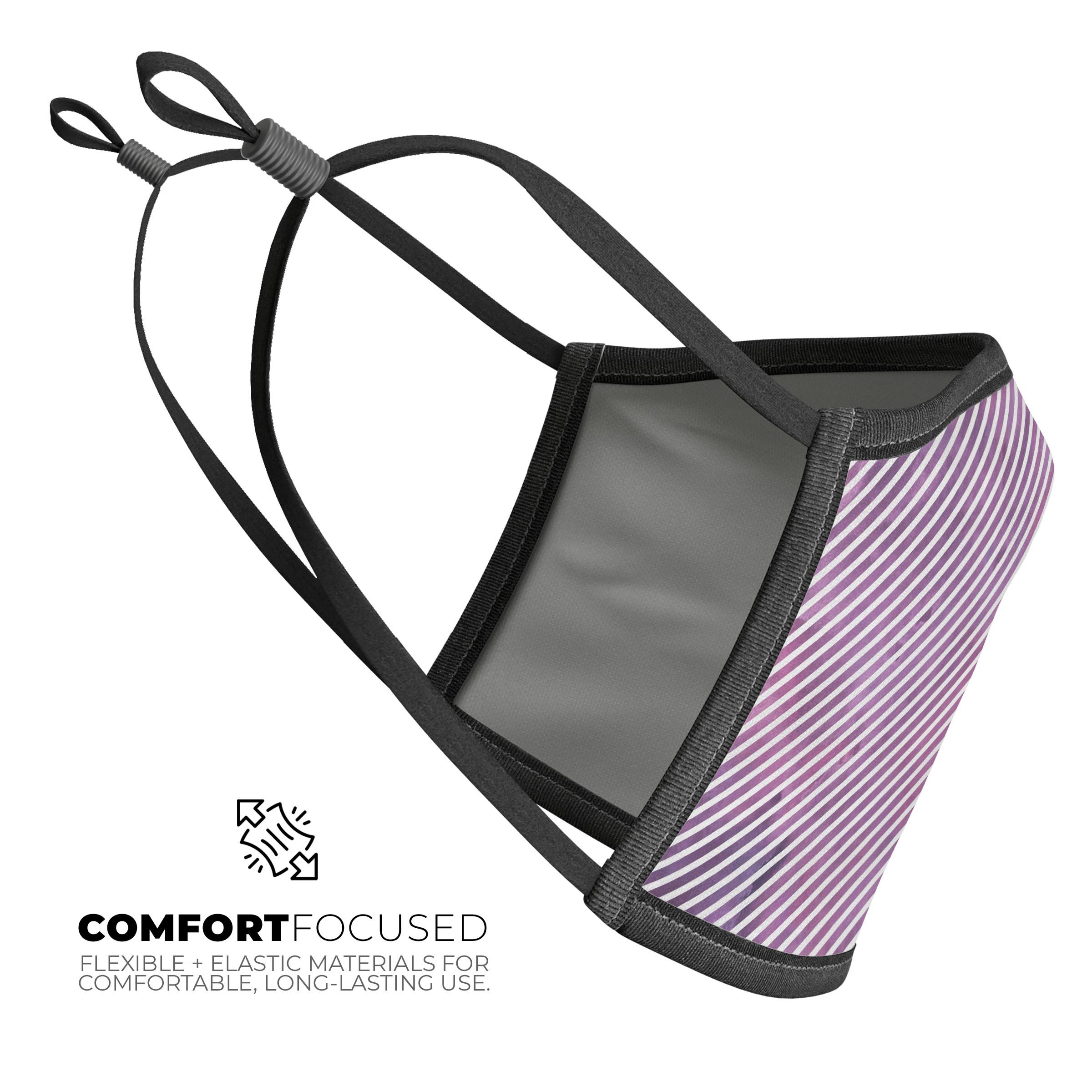 A stylish mouth cover featuring white slanted lines over pink fumes, designed for comfort and adjustable fit, made in the USA.