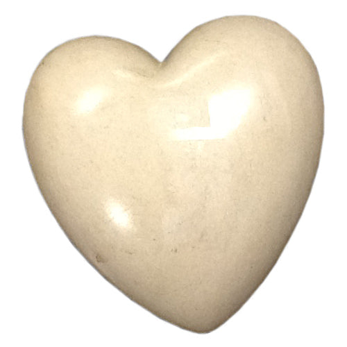 A beautifully crafted White Soapstone Heart, handmade by Haitian artisans, showcasing smooth texture and elegant design.