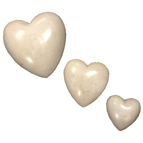 A beautifully crafted White Soapstone Heart, handmade by Haitian artisans, showcasing smooth texture and elegant design.