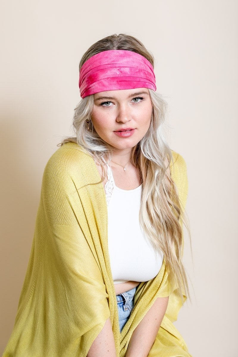 Wide tie-dye headband featuring a colorful and bold print, made from soft elastic material for a comfortable fit.