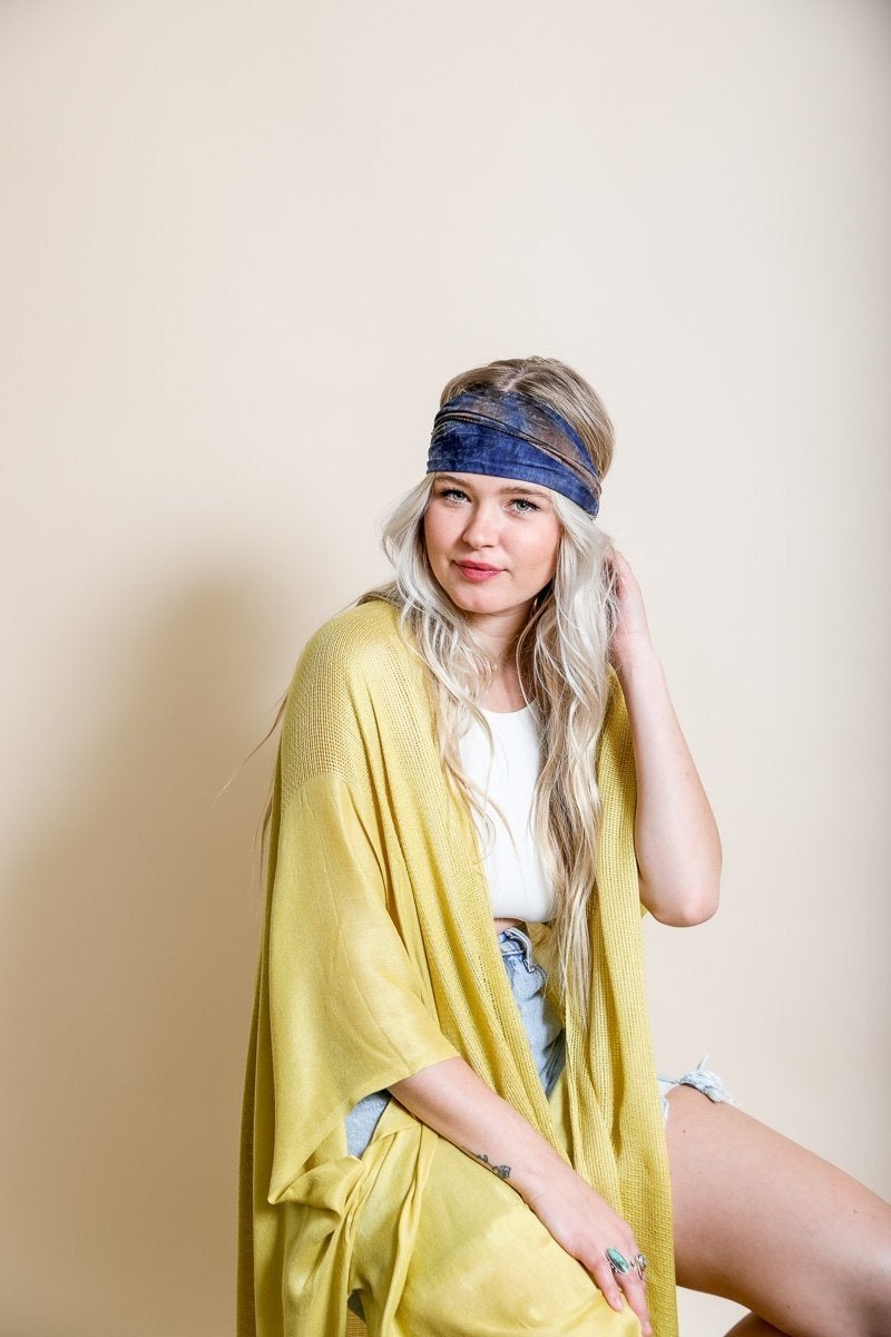 Wide tie-dye headband featuring a colorful and bold print, made from soft elastic material for a comfortable fit.