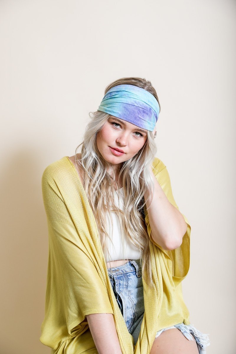 Wide tie-dye headband featuring a colorful and bold print, made from soft elastic material for a comfortable fit.