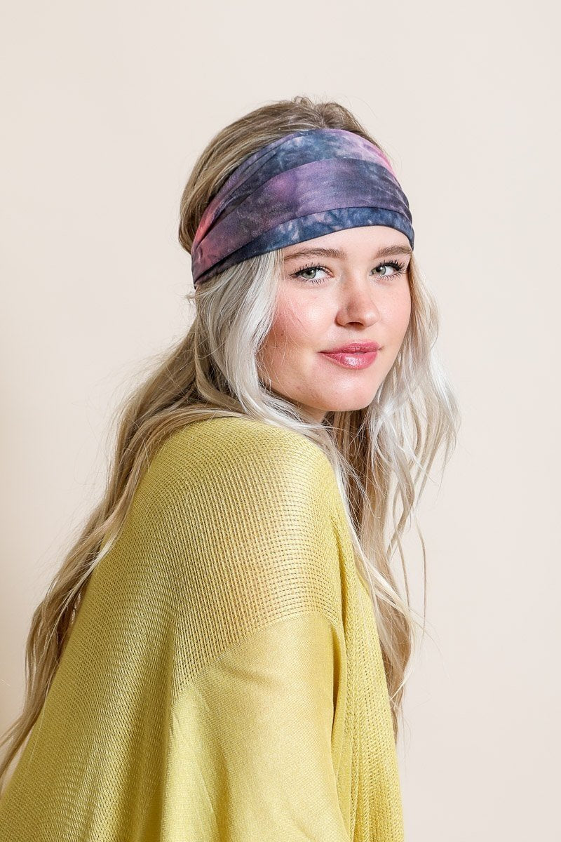 Wide tie-dye headband featuring a colorful and bold print, made from soft elastic material for a comfortable fit.