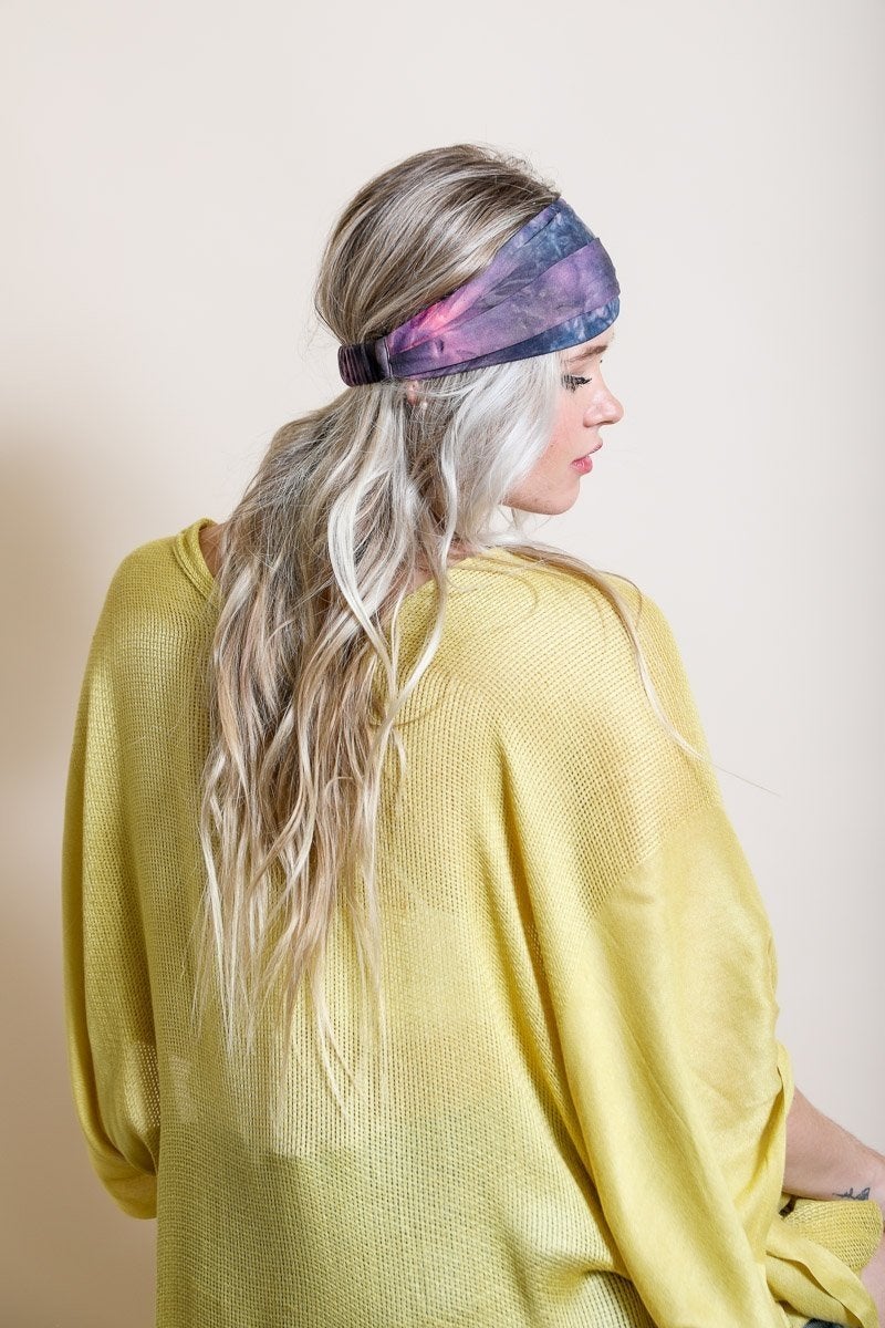 Wide tie-dye headband featuring a colorful and bold print, made from soft elastic material for a comfortable fit.