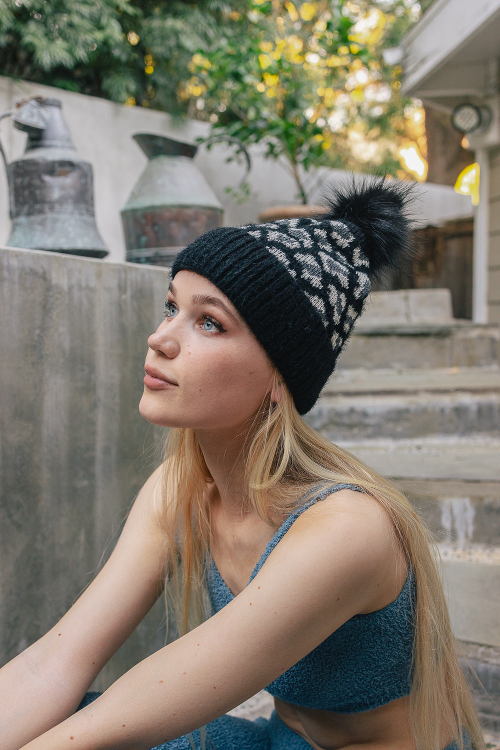 A cozy Wild Leopard Knit Beanie featuring a stylish leopard print design and a playful pom-pom on top, perfect for winter wear.