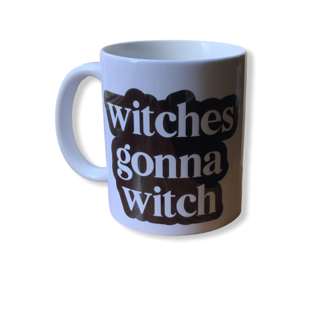 A whimsical 11oz ceramic mug with 'Witches Gonna Witch' design printed on both sides, perfect for hot or cold beverages.