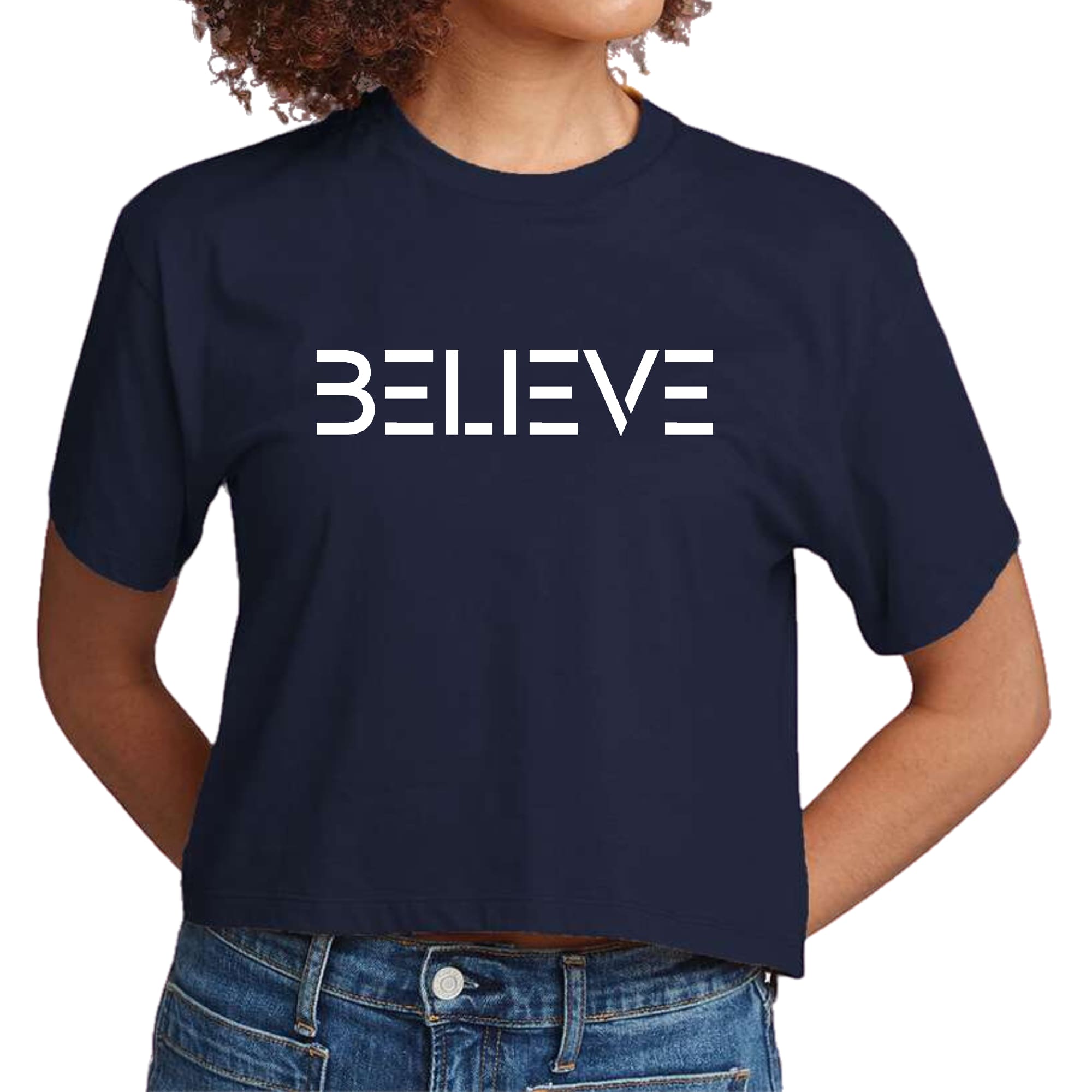 Women's cropped graphic t-shirt in white featuring an inspirational 'Believe' print, made from soft preshrunk cotton.