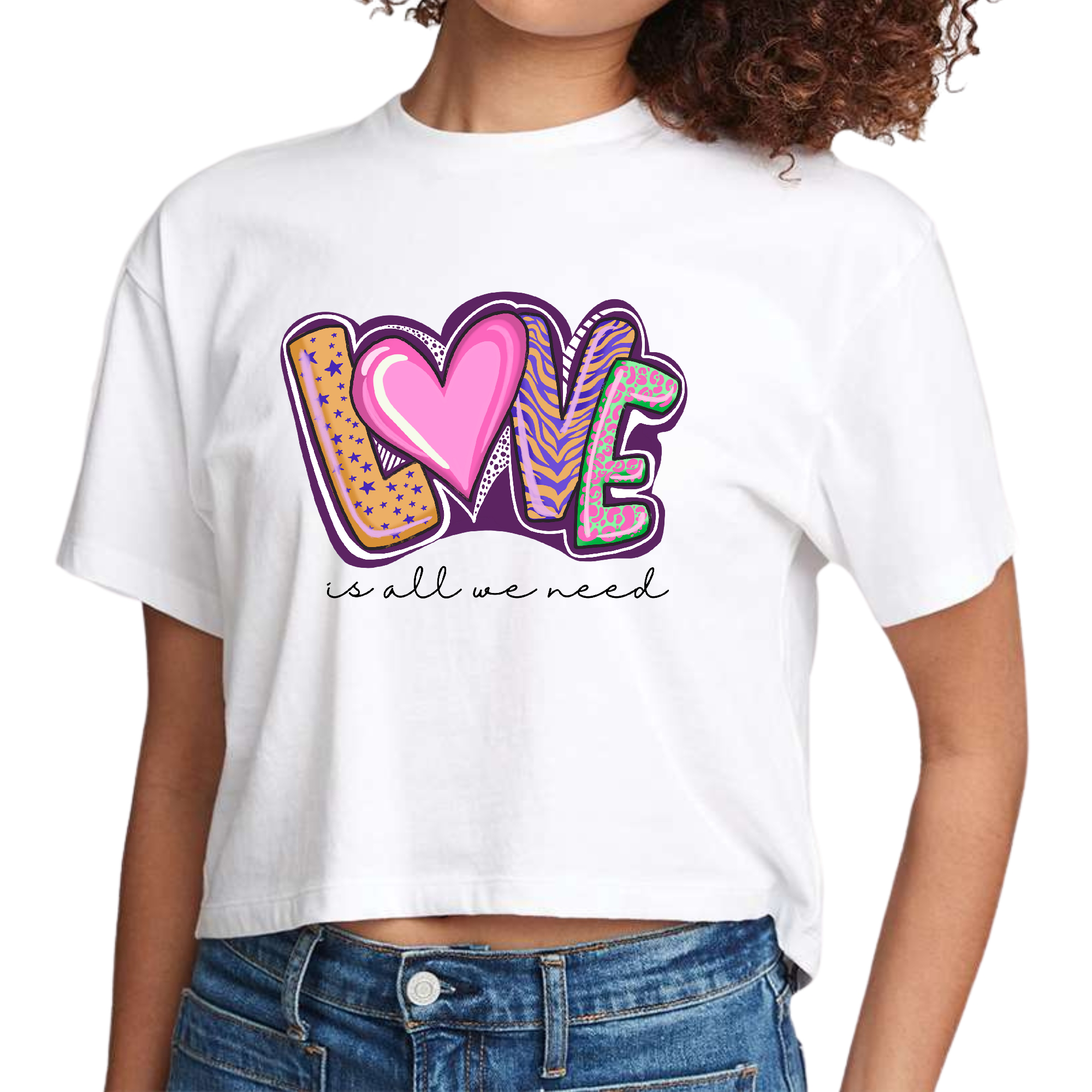 Womens Cropped Graphic T-shirt featuring the phrase 'Love is All we Need' in a stylish design, made from soft cotton fabric.