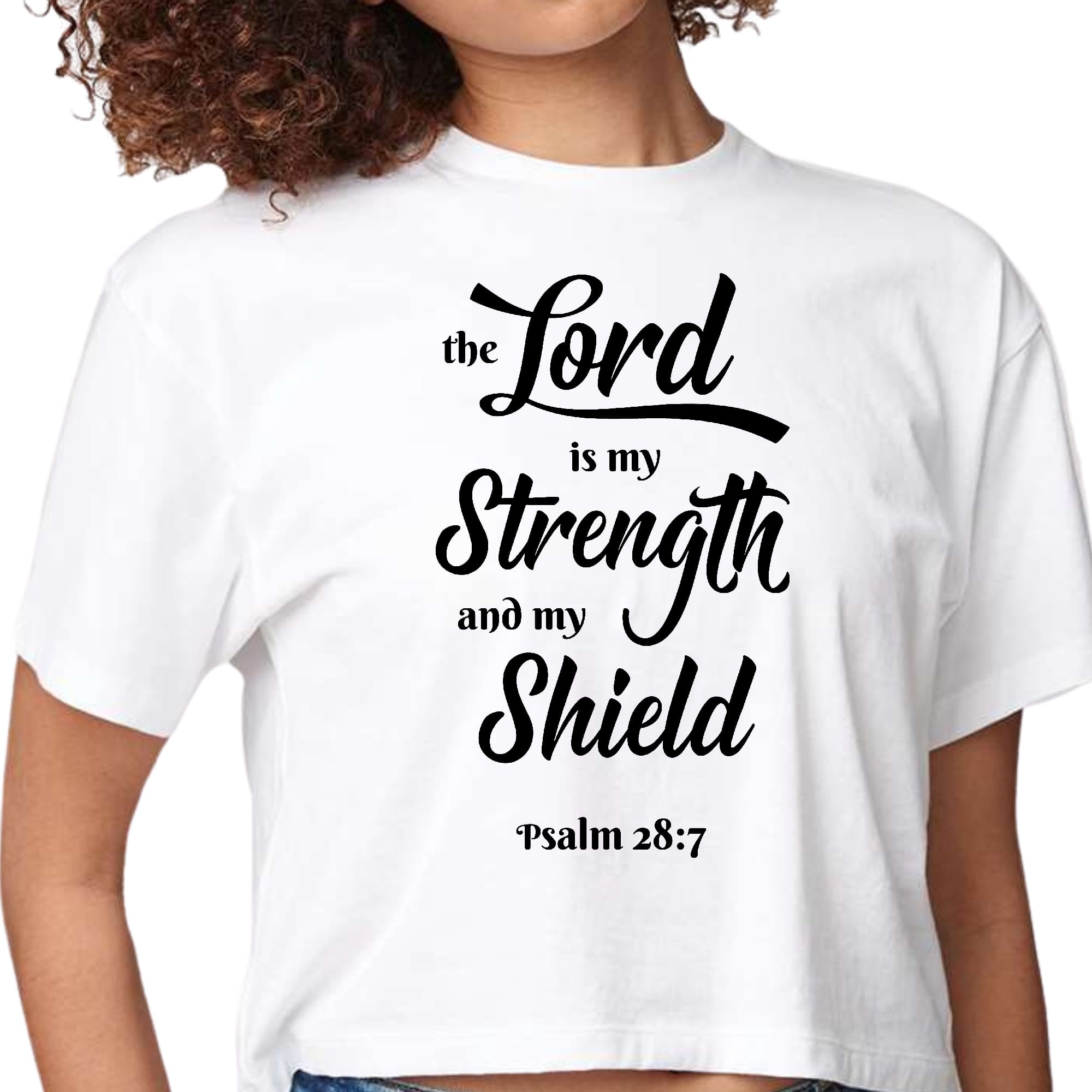 Women's cropped graphic t-shirt with black print saying 'The Lord is my Strength and my Shield', showcasing a modern and artistic design.