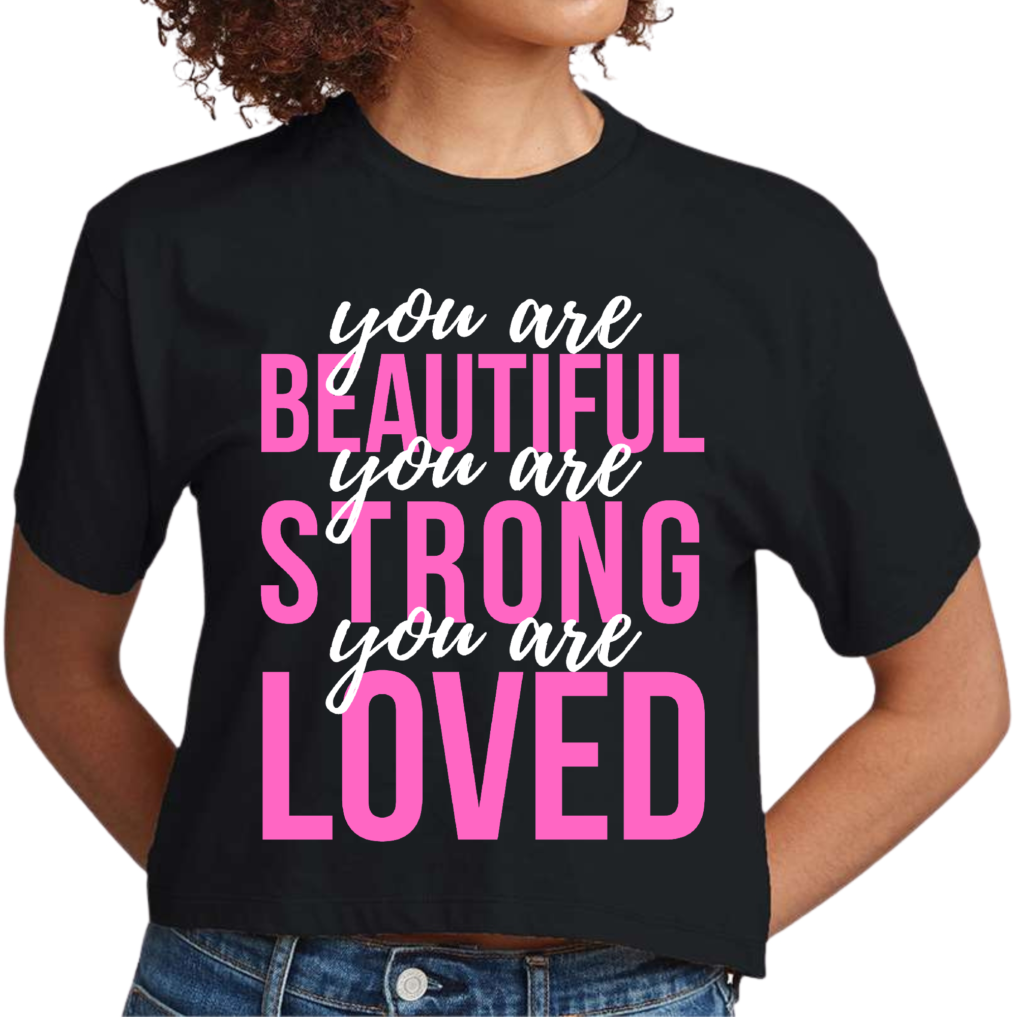 A women's cropped graphic t-shirt in pink and white featuring the inspirational text 'You Are Beautiful Strong Loved' on the front.