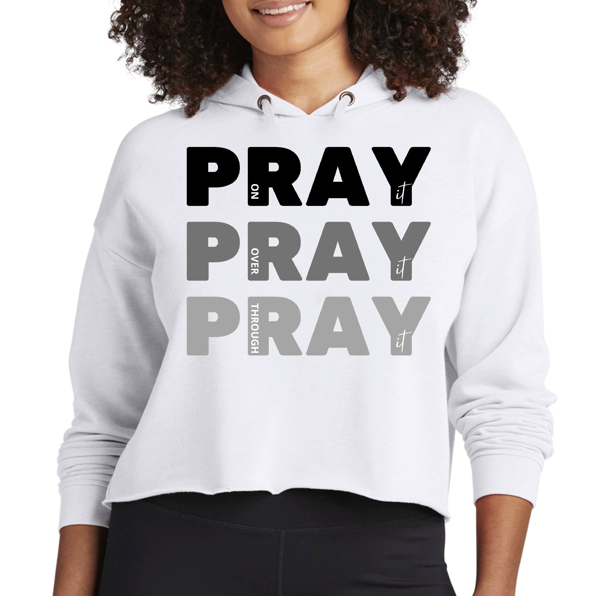 Women's cropped hoodie in black with 'Pray On It Over It Through It' inspirational print, featuring a relaxed fit and double fabric hood.