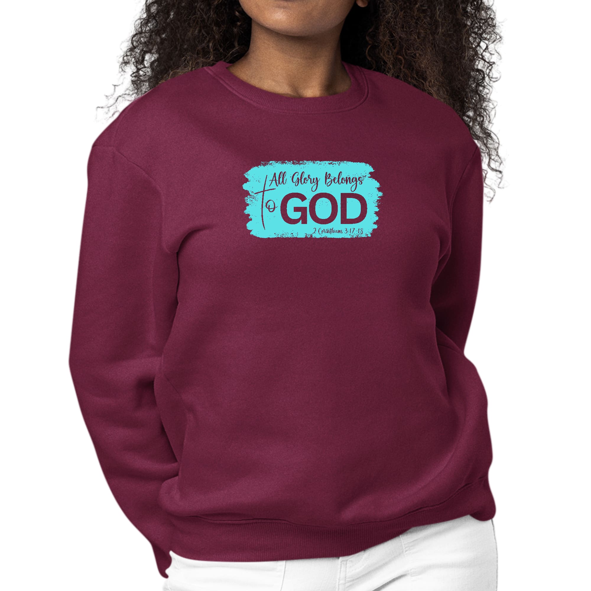 Women's long sleeve crewneck sweatshirt with 'All Glory Belongs to God' graphic in cyan, showcasing comfort and style.