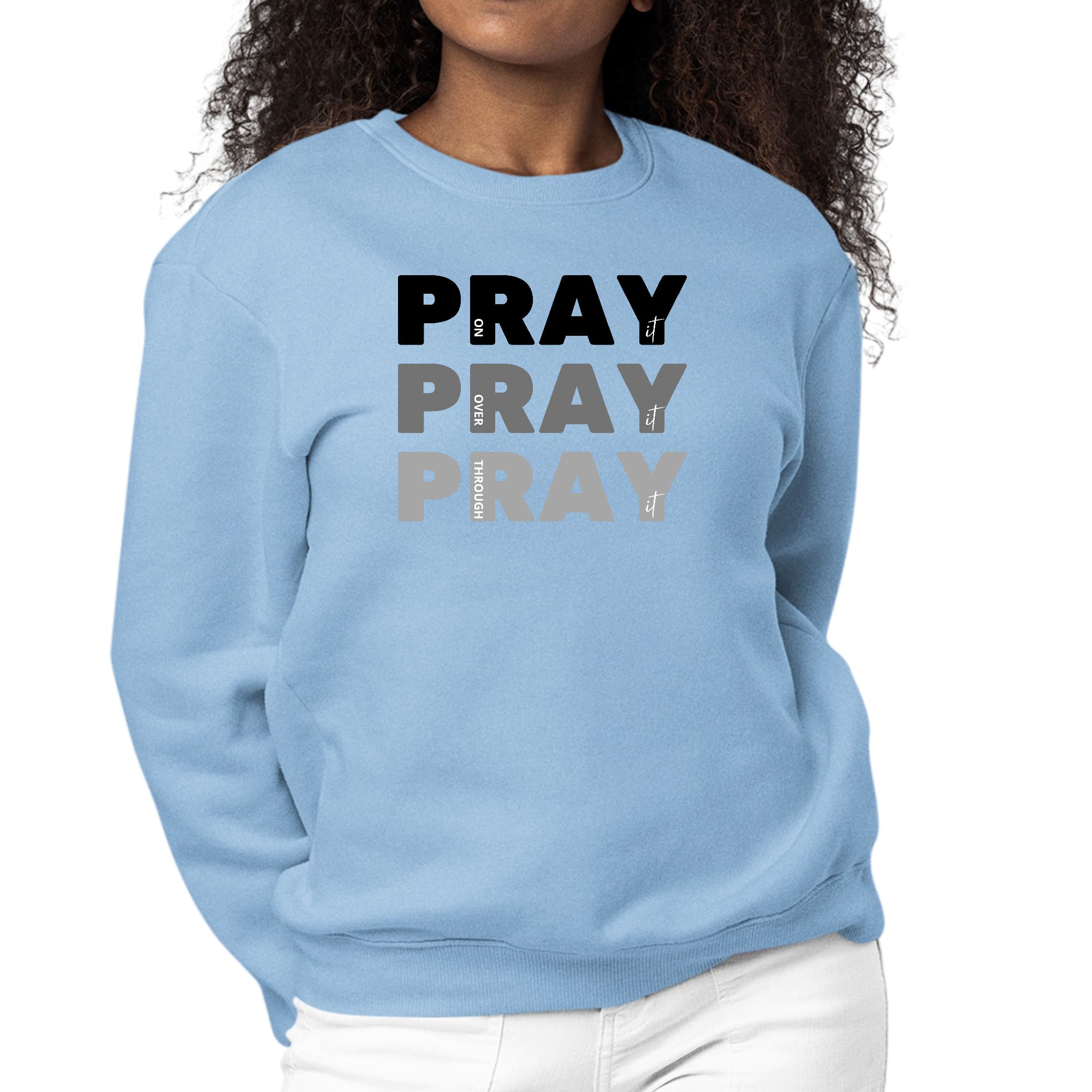 Women's black graphic sweatshirt with 'Pray On It Over It Through It' print, featuring long sleeves and a crewneck design.