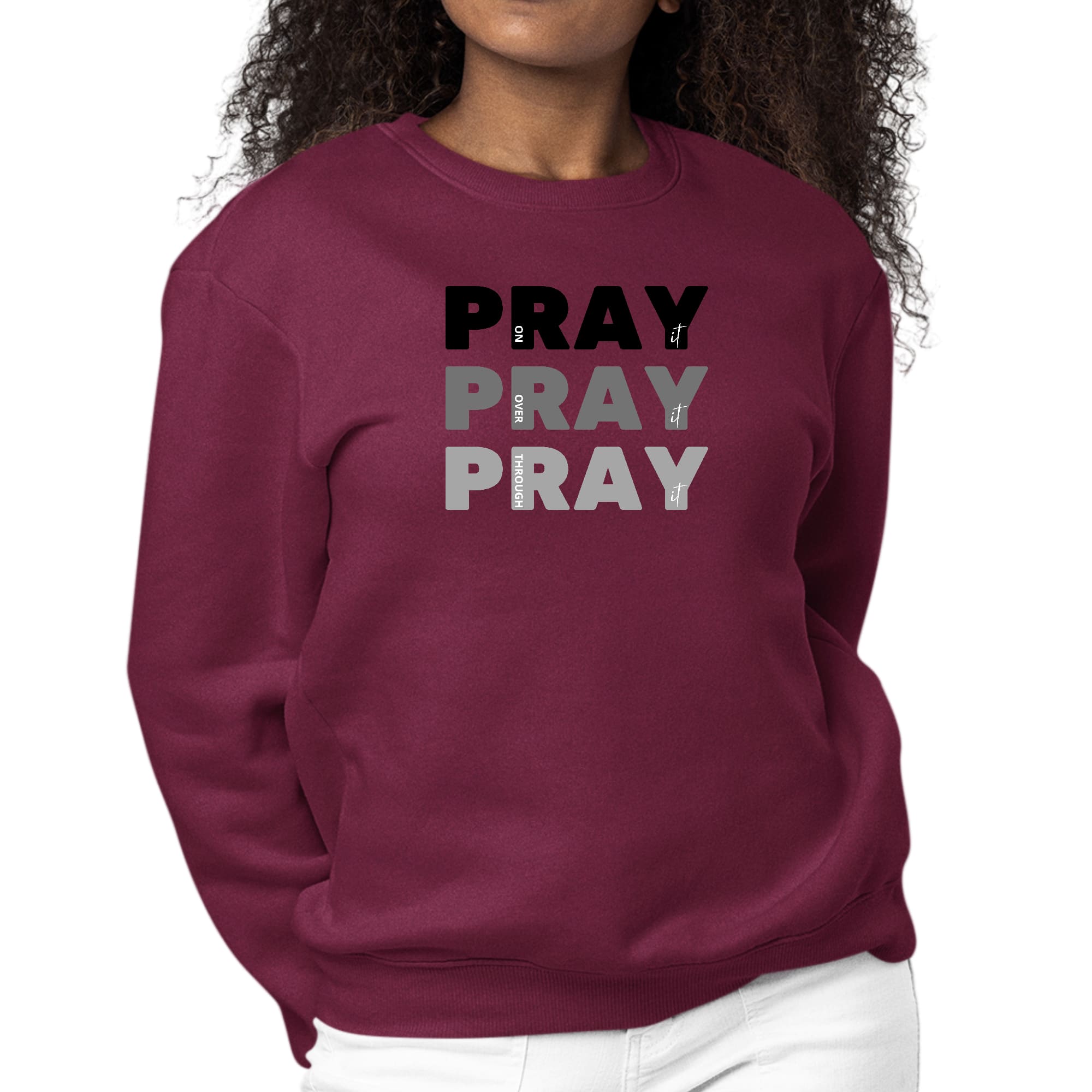 Women's black graphic sweatshirt with 'Pray On It Over It Through It' print, featuring long sleeves and a crewneck design.