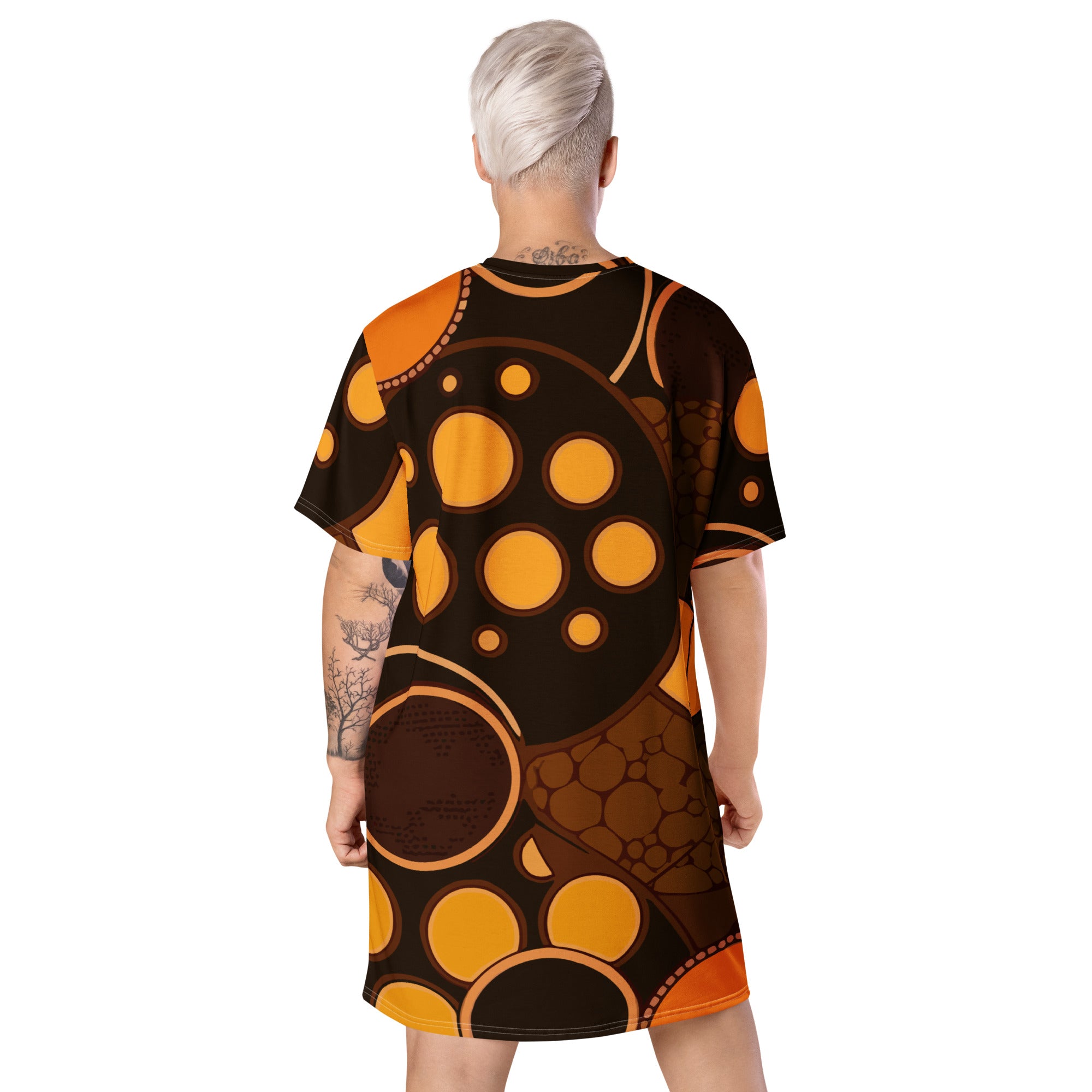 Womens Graphic T-shirt Dress featuring an orange and brown spotted print, showcasing its oversized fit and stylish design.