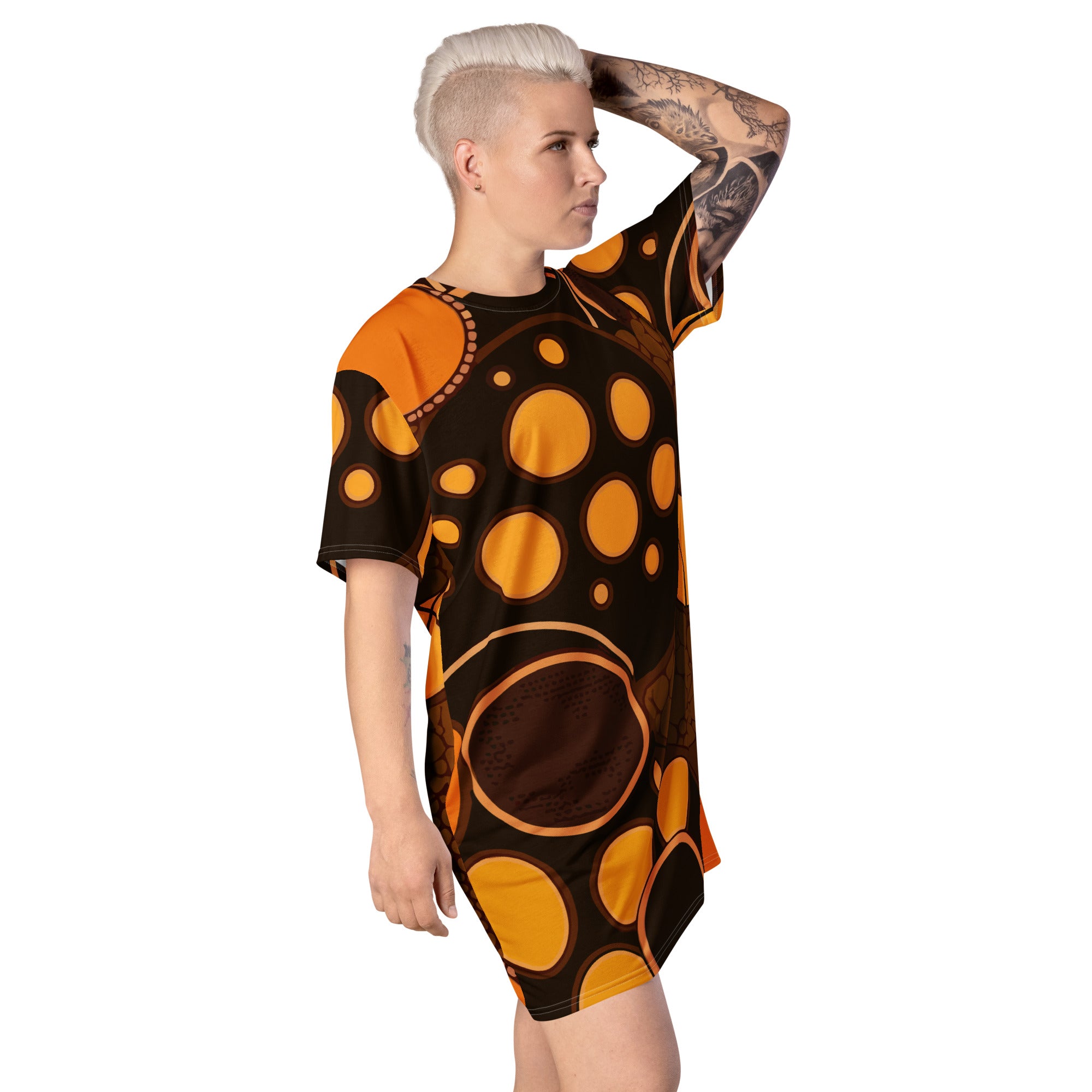 Womens Graphic T-shirt Dress featuring an orange and brown spotted print, showcasing its oversized fit and stylish design.