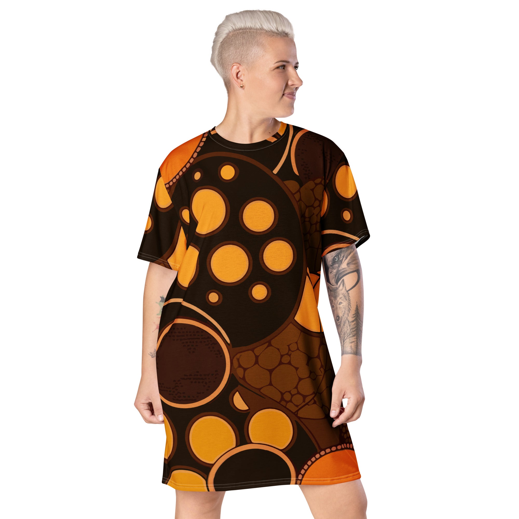 Womens Graphic T-shirt Dress featuring an orange and brown spotted print, showcasing its oversized fit and stylish design.