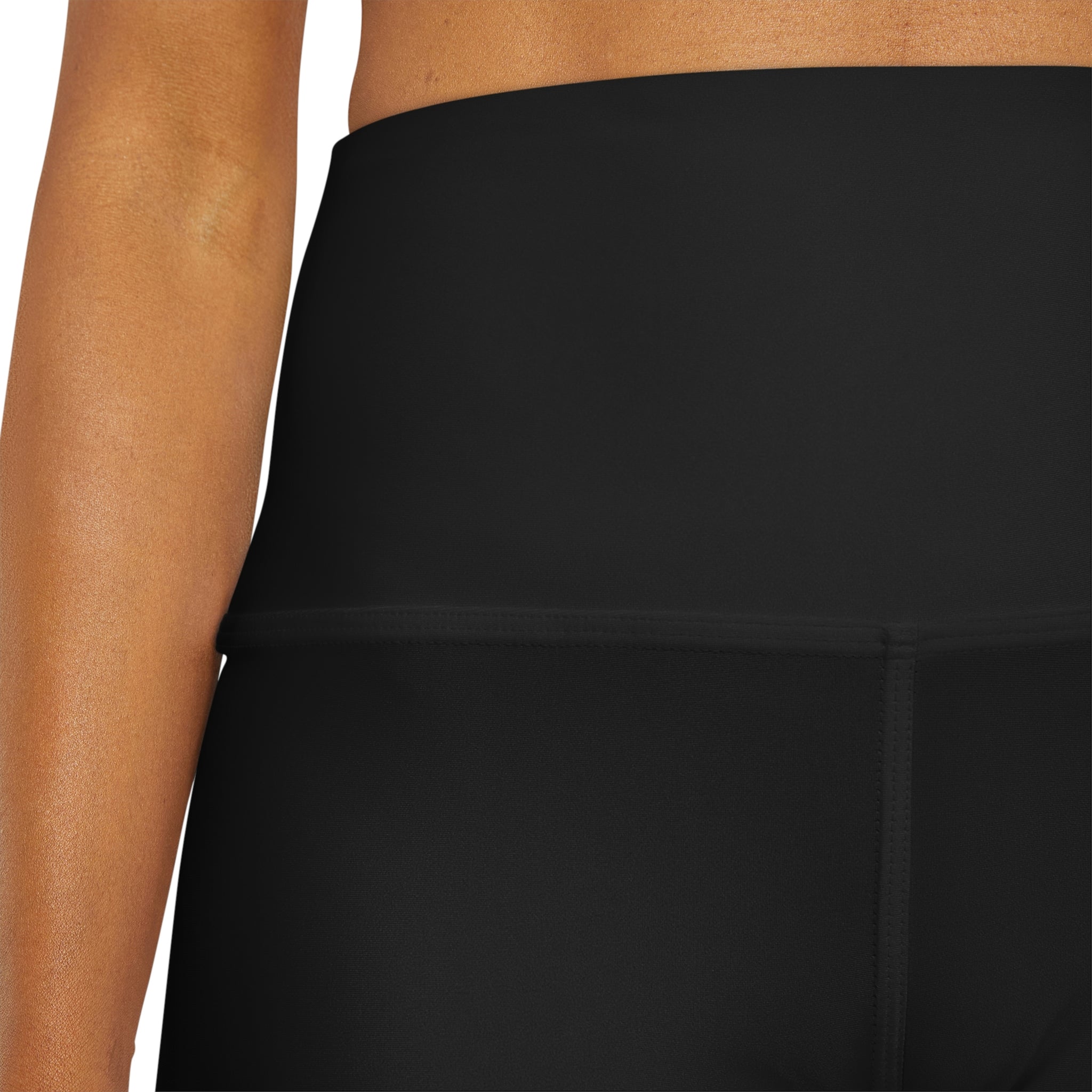 A pair of women's high waisted black yoga shorts with a wide waistband, showcasing a soft fabric ideal for workouts and casual wear.