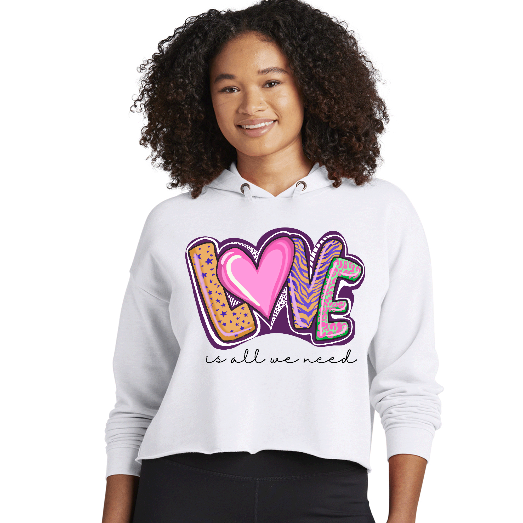 Womens cropped performance hoodie in black with 'Love is All we Need' graphic, featuring a drawstring hood and raw edge hem.