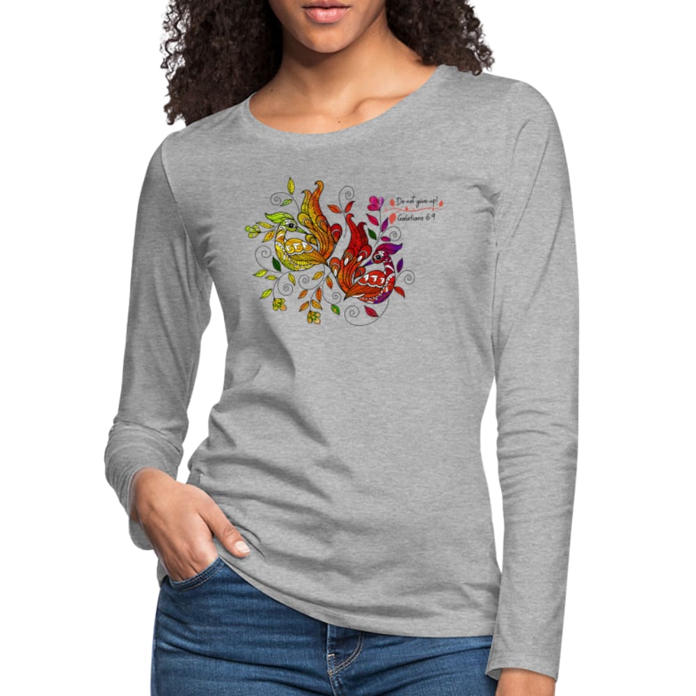 A vibrant women's long sleeve graphic tee featuring a colorful peacock print and affirmations, showcasing its soft cotton fabric and stylish design.