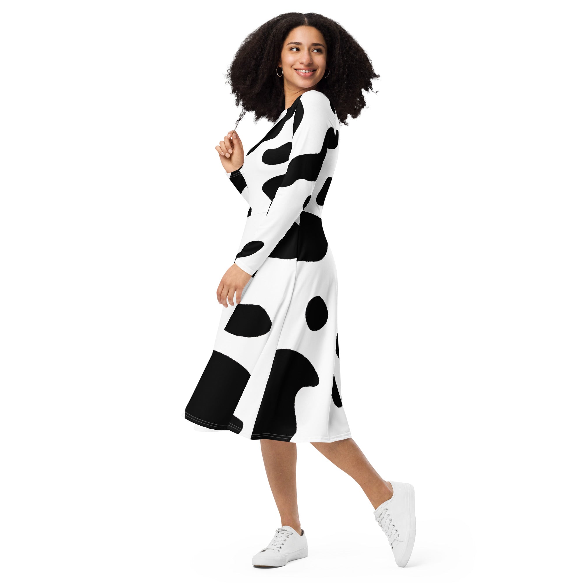 Womens Long Sleeve Midi Dress featuring a stylish black and white cow print, showcasing a fitted waist and flared bottom with side pockets.