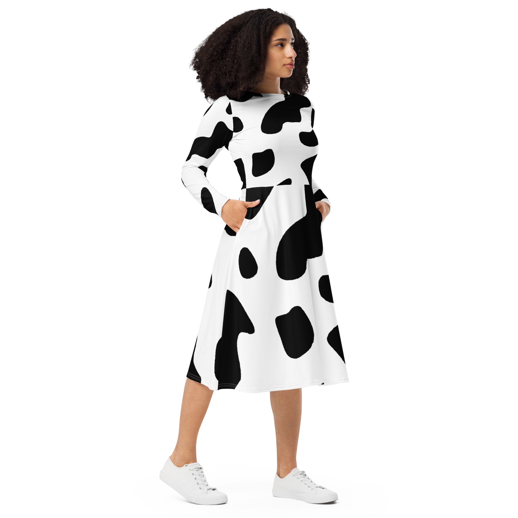 Womens Long Sleeve Midi Dress featuring a stylish black and white cow print, showcasing a fitted waist and flared bottom with side pockets.